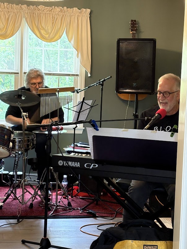 a group of people playing music in a living room