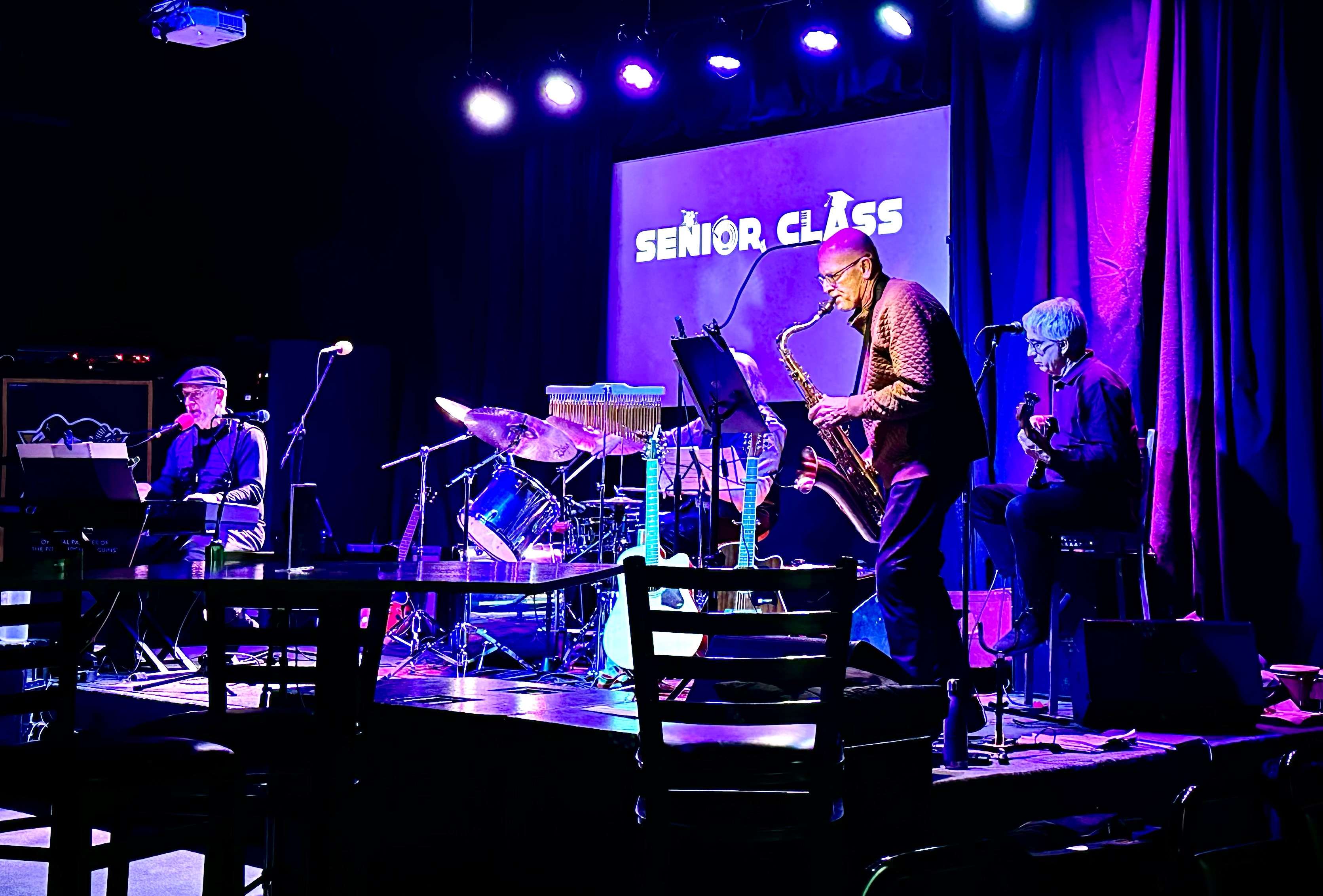 a group of musicians on stage in a dark room