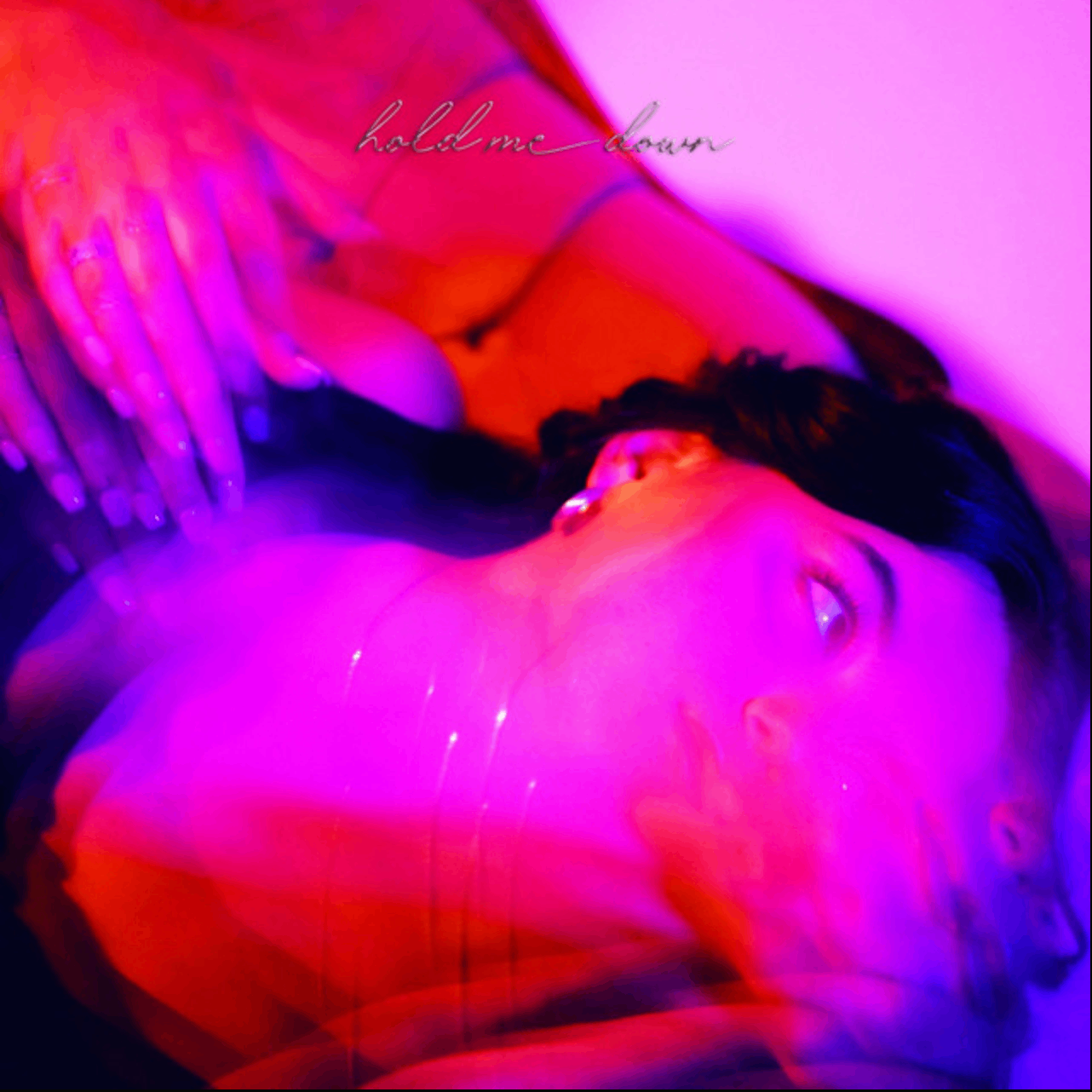 a woman laying down in a purple light