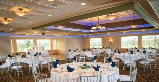a banquet room set up with tables and chairs