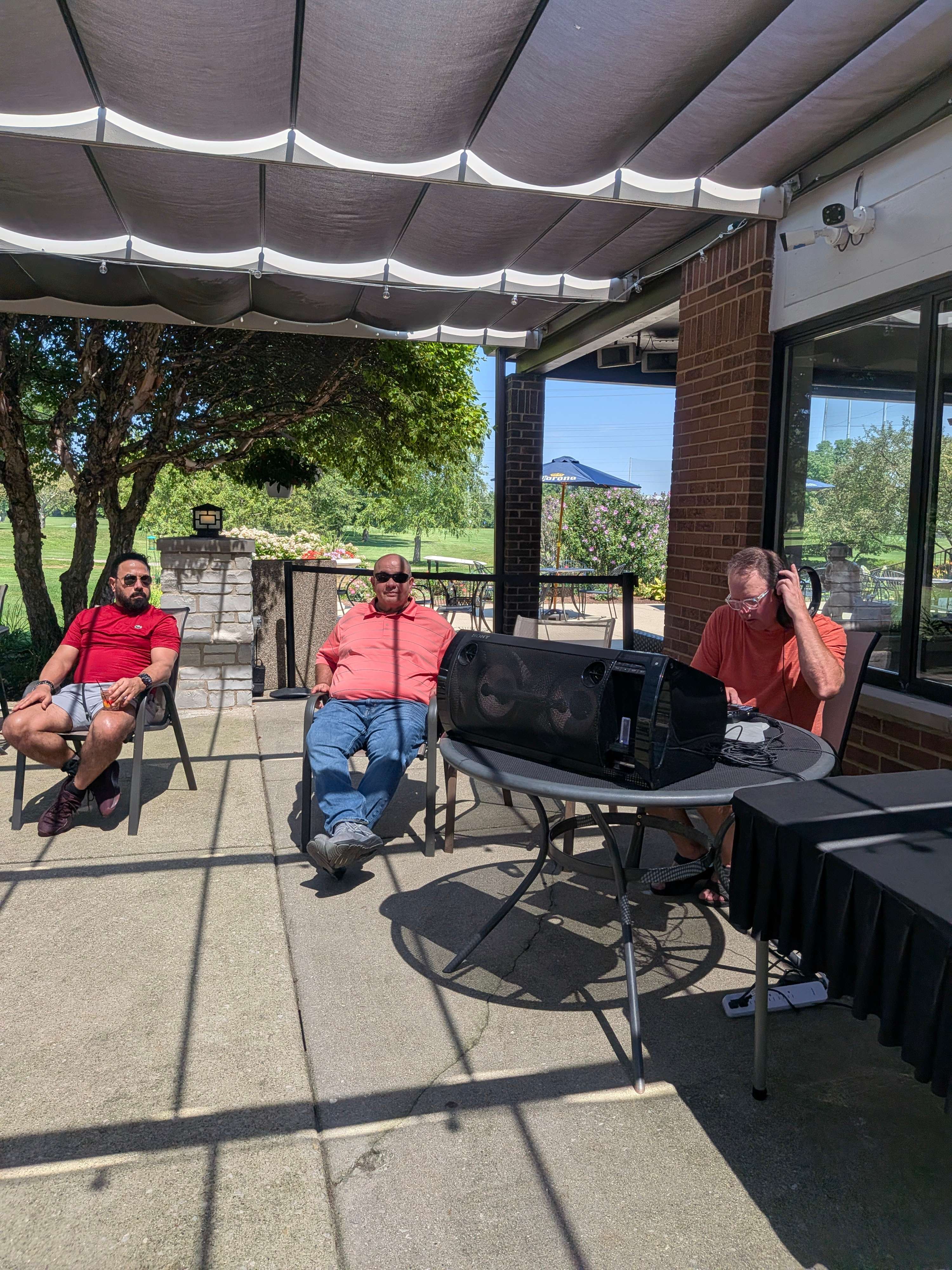 a group of people sitting at a table under a canopy