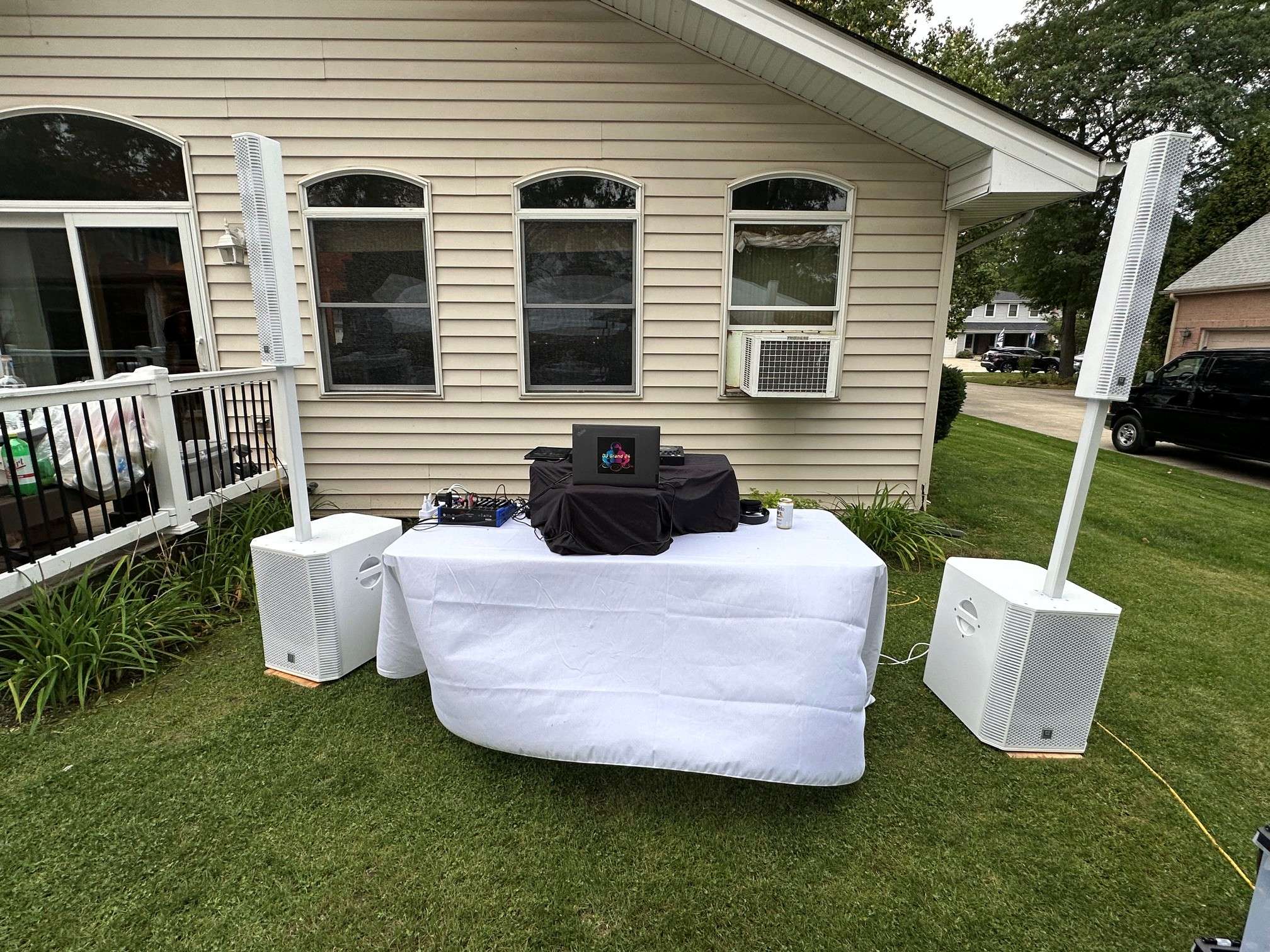 a dj set up in the yard of a house