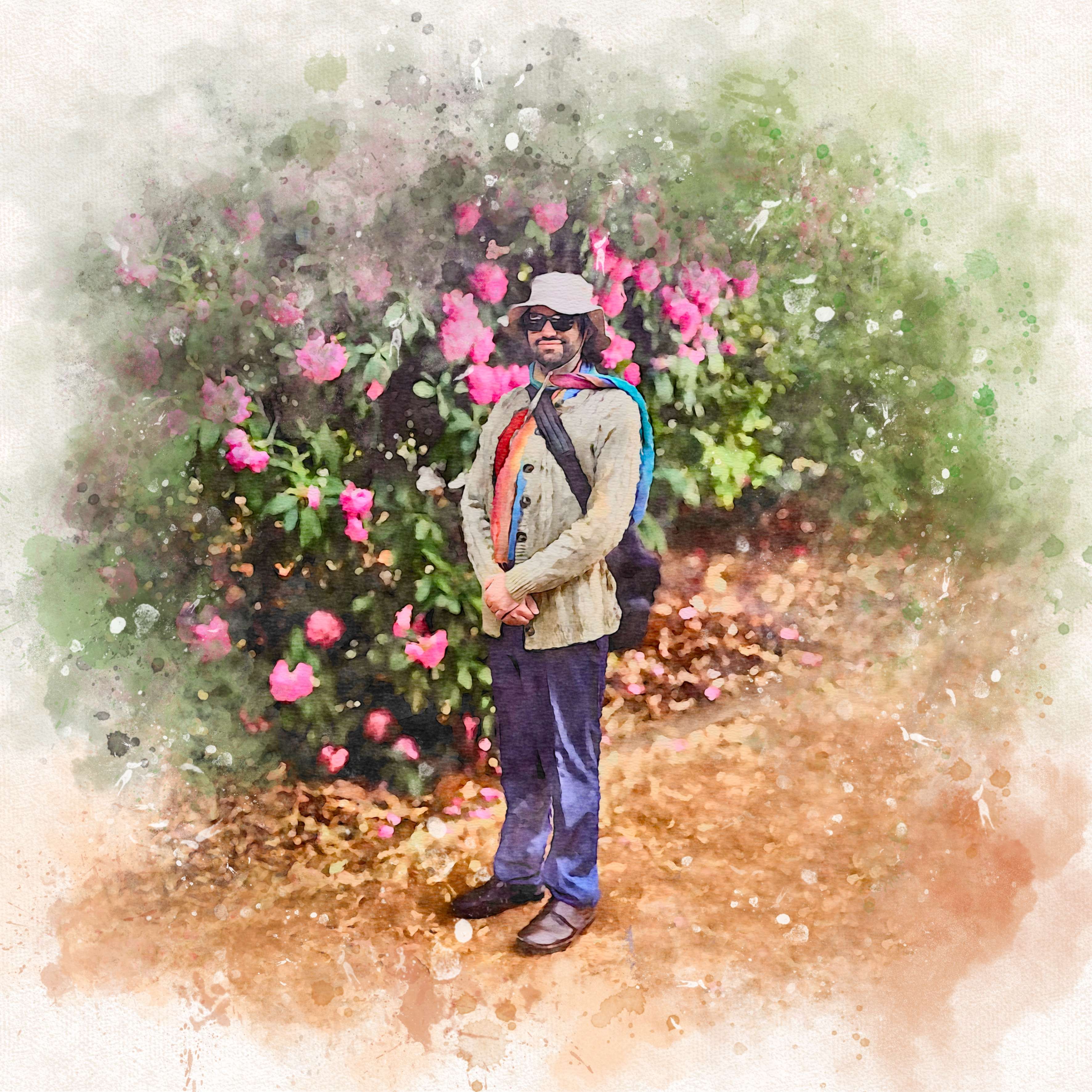 a man is standing in front of a flowering bush