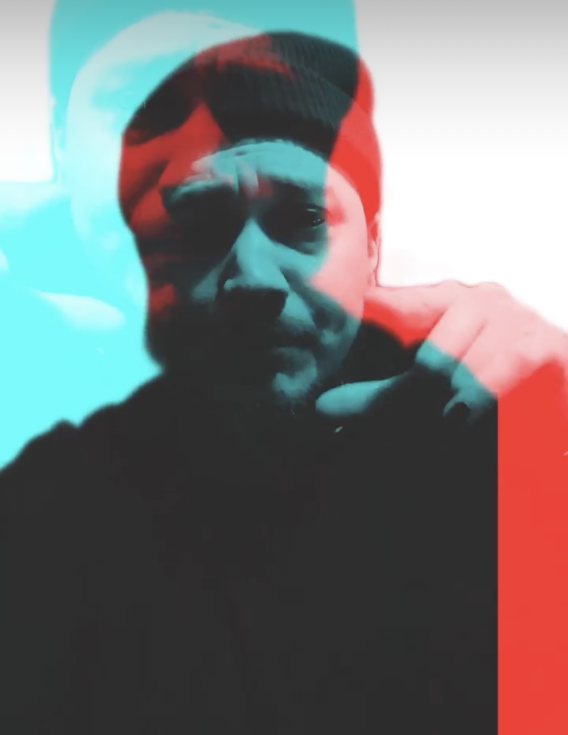 a man with a beanie and a red and blue background