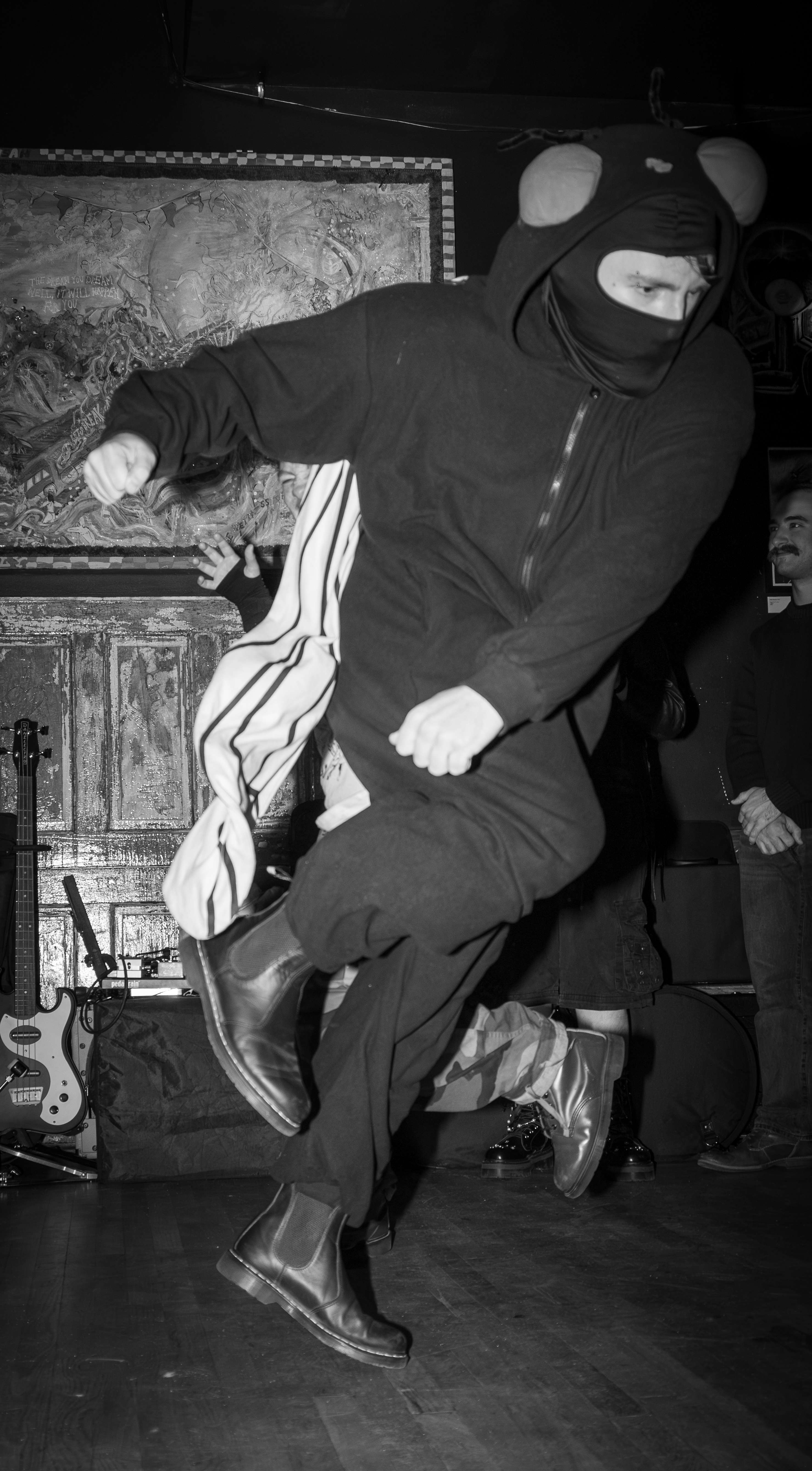 a black and white photo of a man in a black hoodie