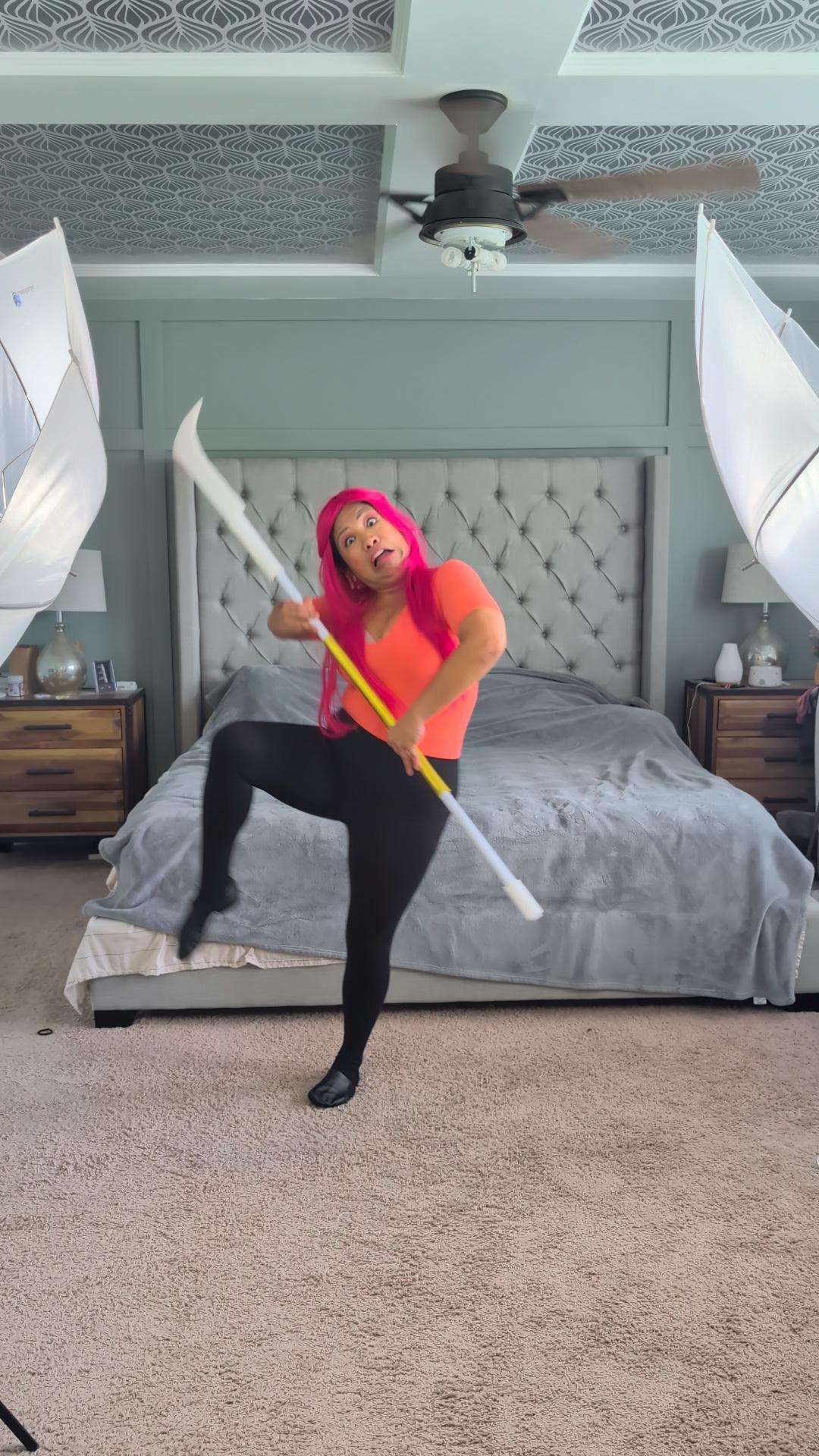 a woman holding a bat in a bedroom