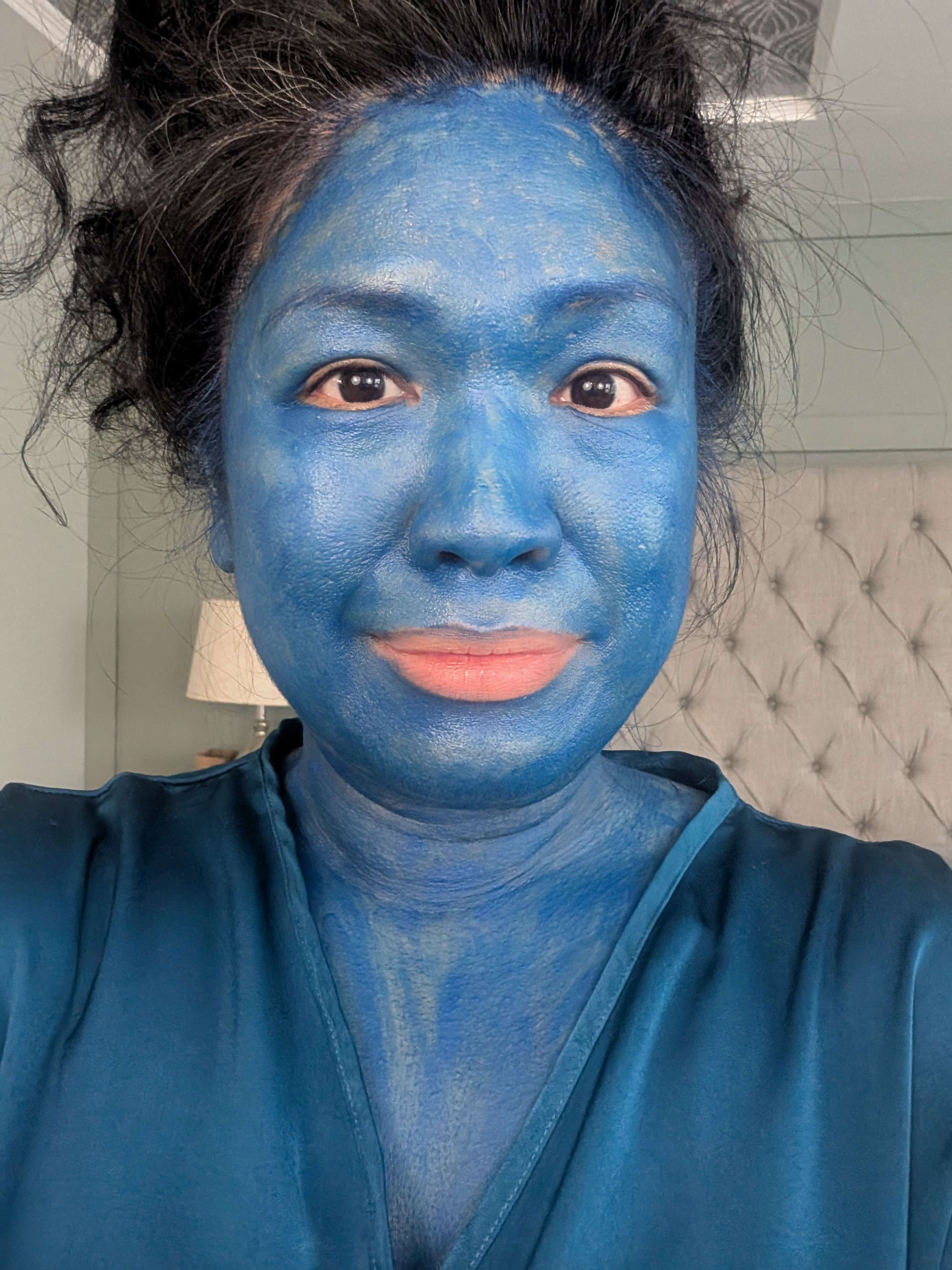 a woman with blue paint on her face