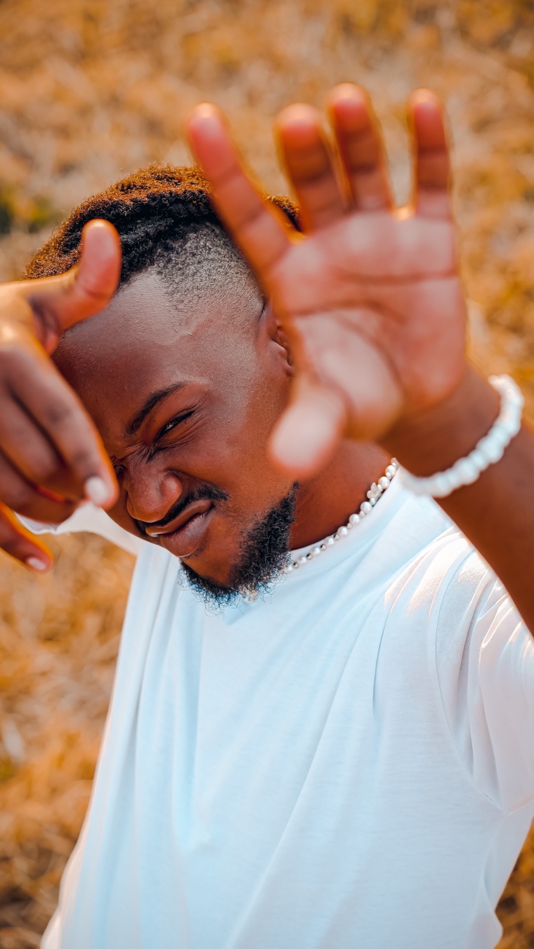 a man is posing with his hands in the air