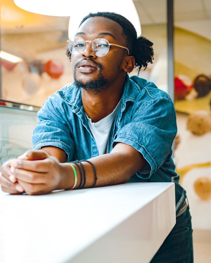 a man leaning over a table in an office