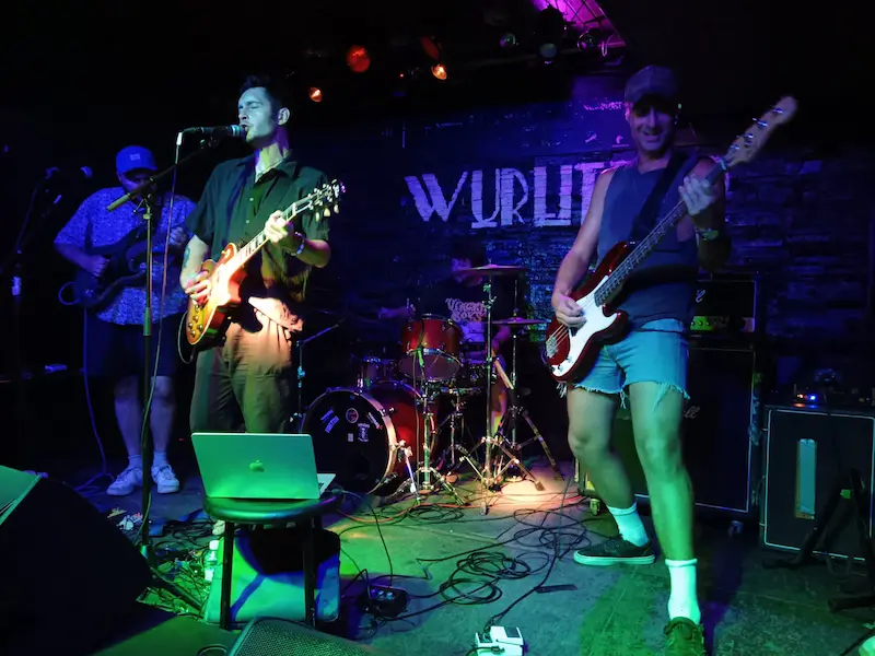 image may contain person, on stage, playing a musical instrument and night