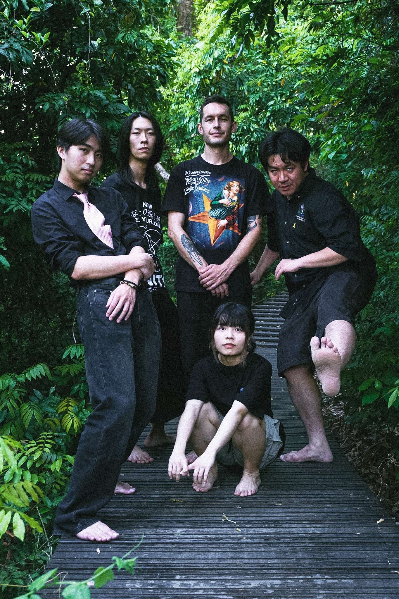 a group of people posing for a picture in the woods
