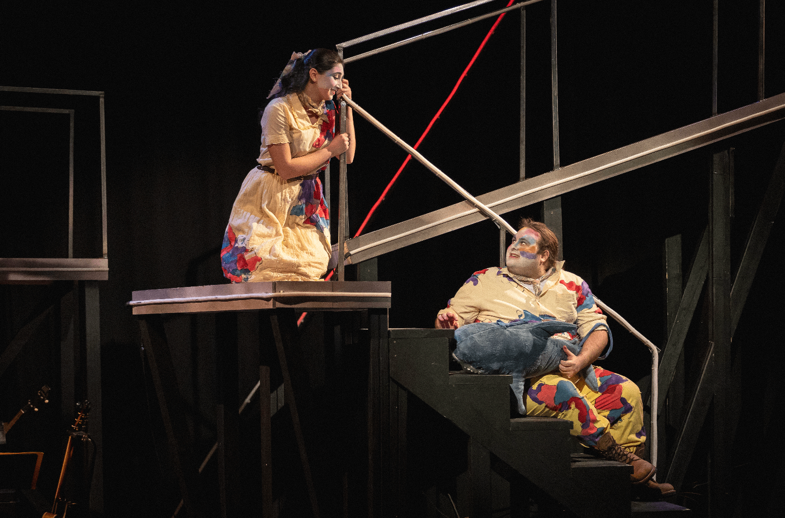 a man and a woman sitting on a set of stairs