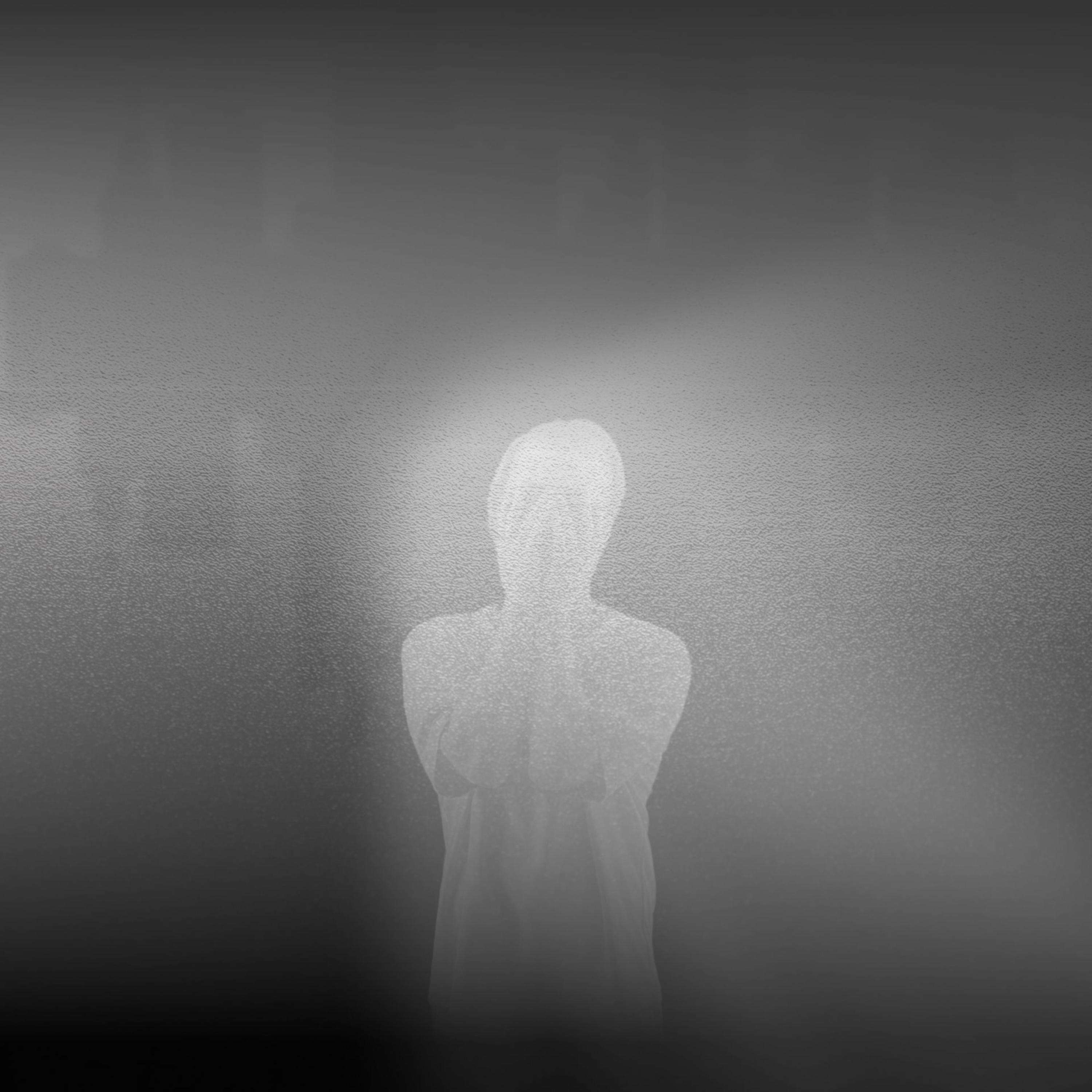 a black and white photo of a person in front of a city