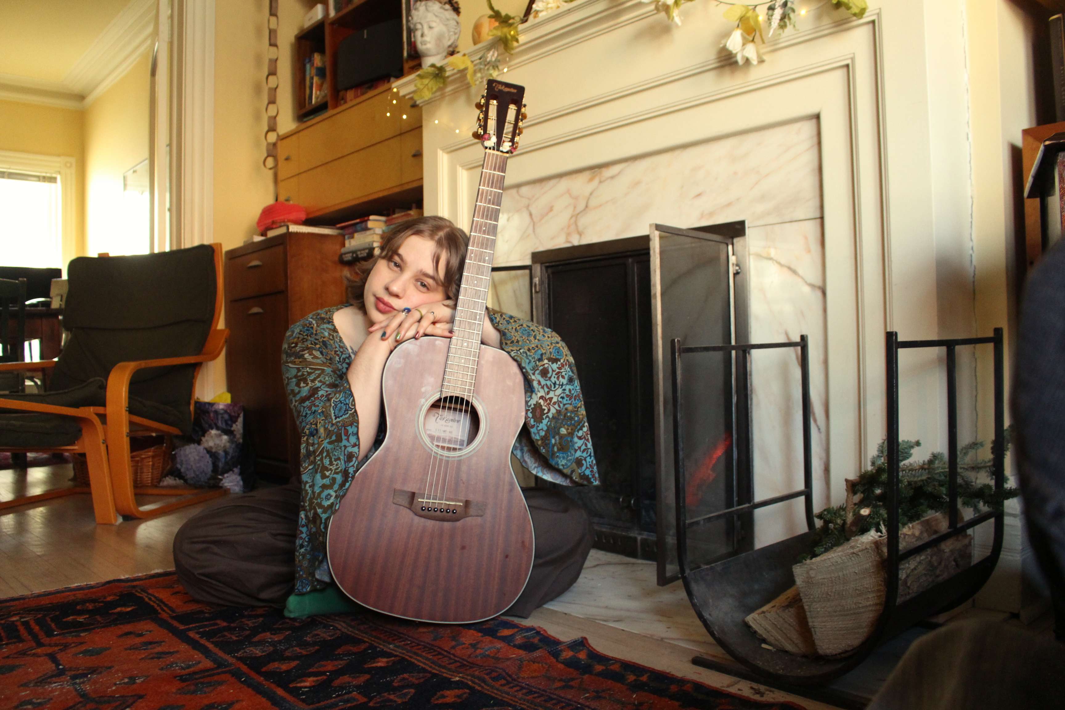 a woman playing an acoustic guitar