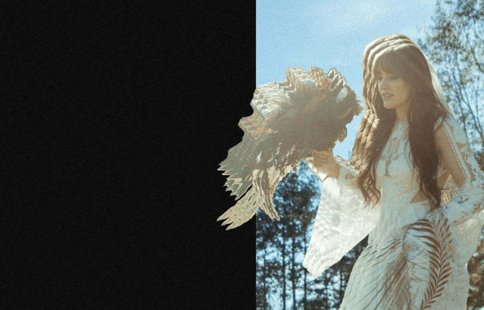 a woman in a white dress holding a feather