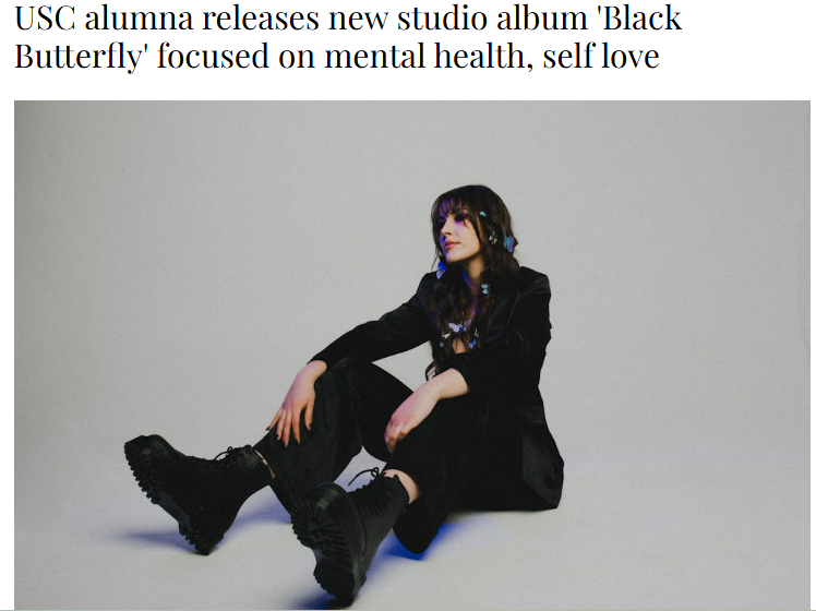 a woman is sitting on the floor with the words black butterfly focused on mental health, health, and love