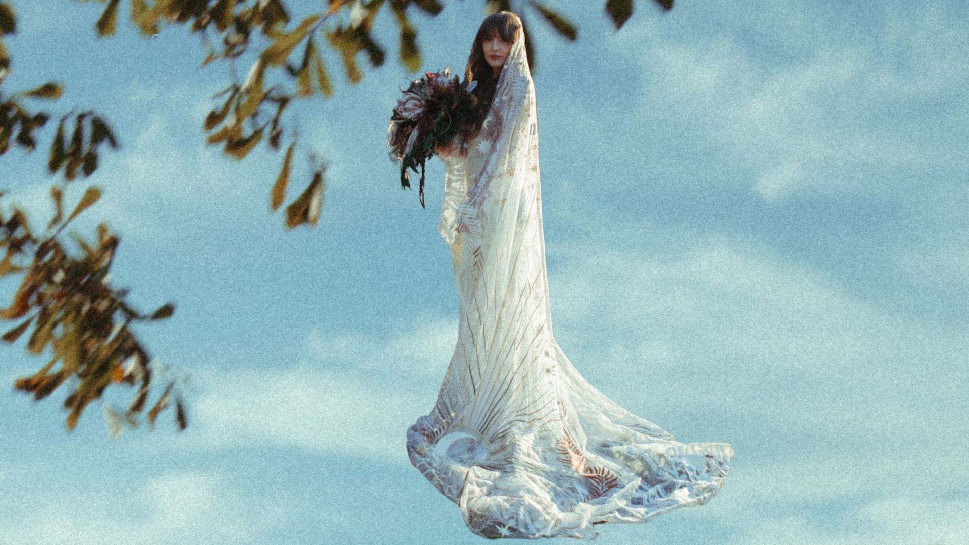 a woman in a wedding dress flying through the air