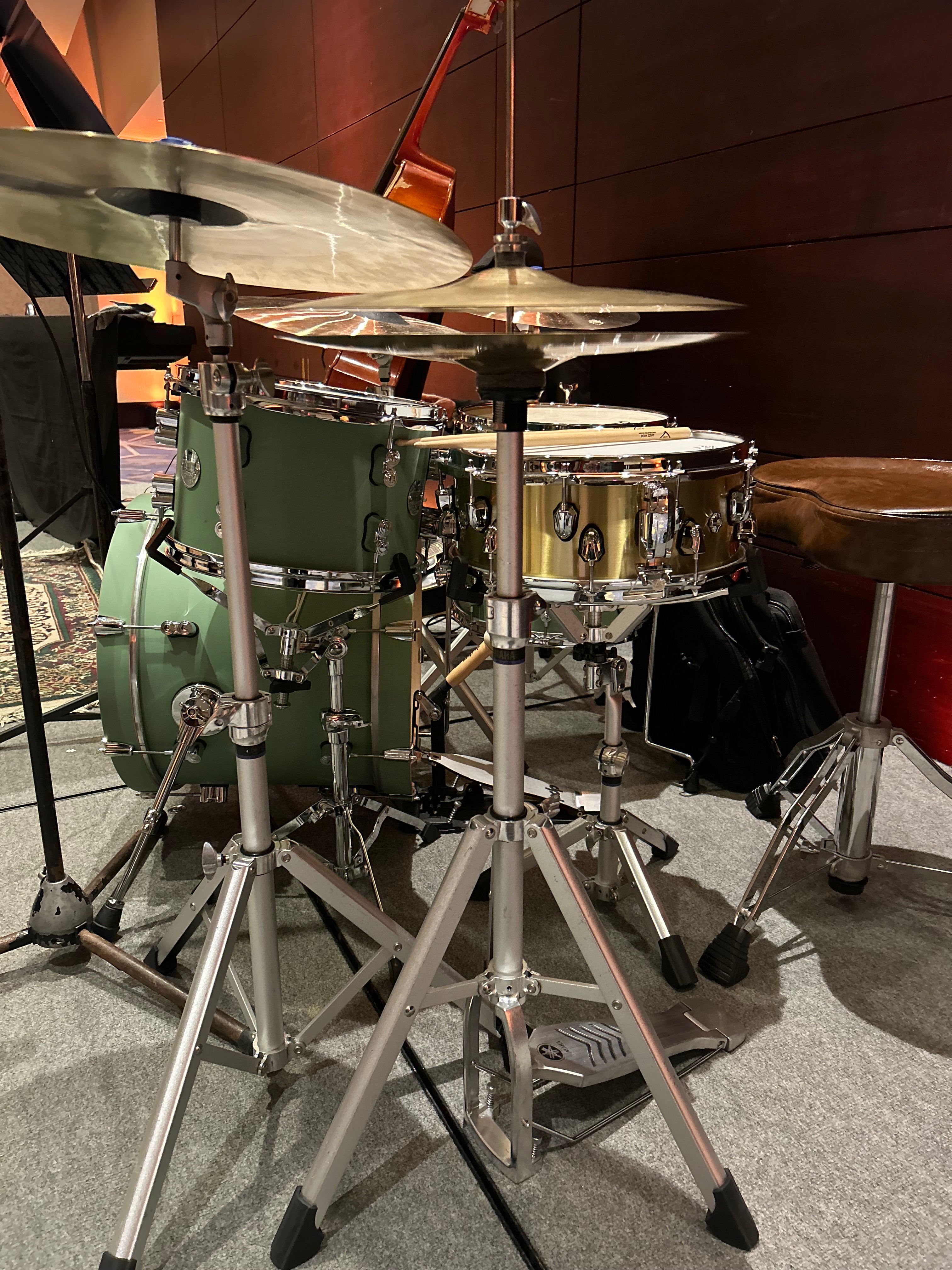 a green drum set is sitting on a stage