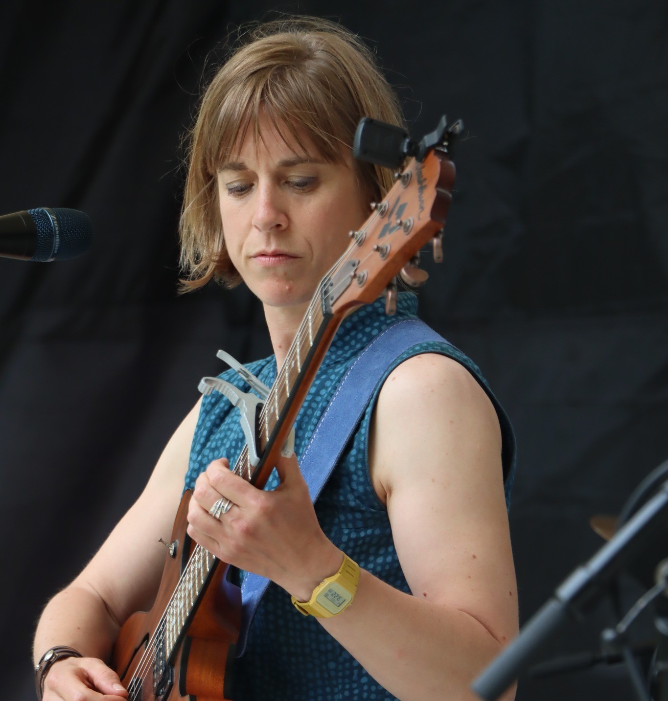 a woman playing an acoustic guitar