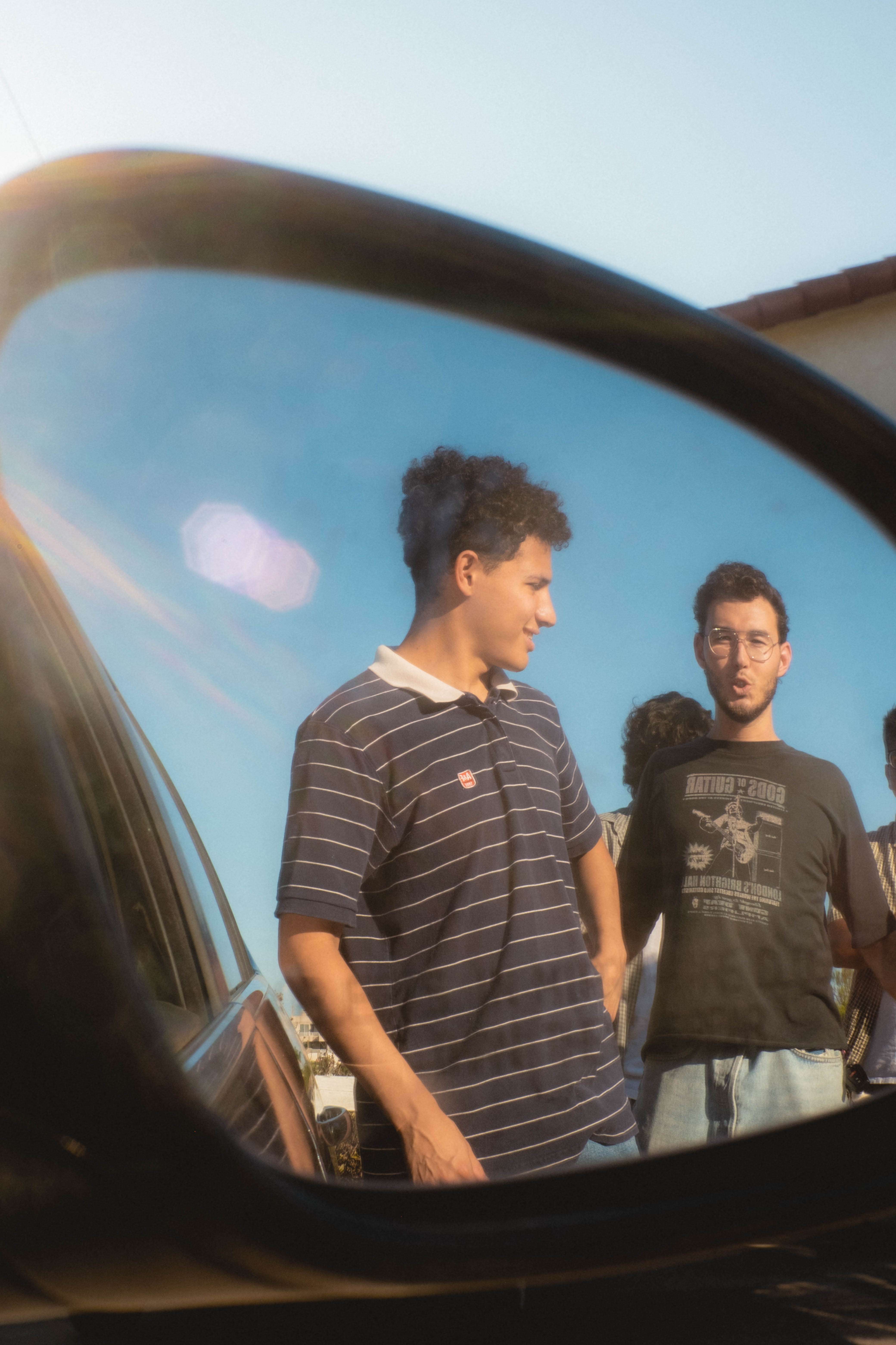 a group of people standing in front of a car