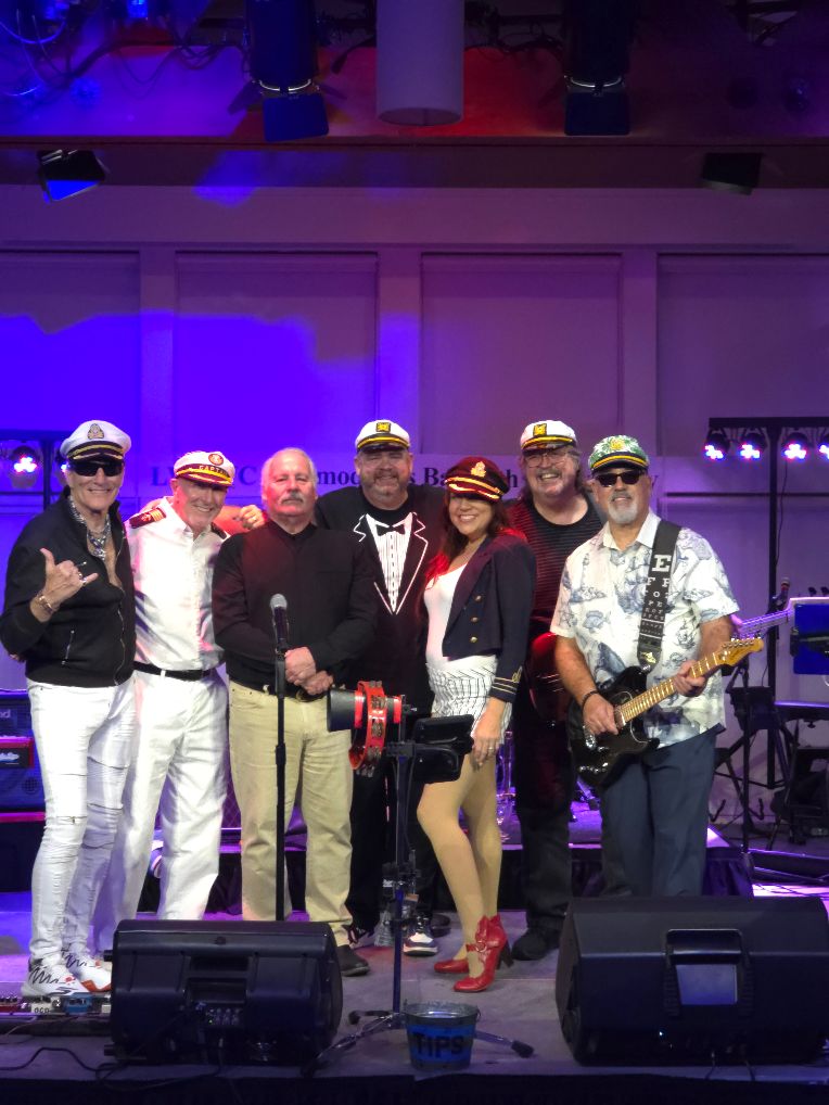 a group of people posing for a picture on stage