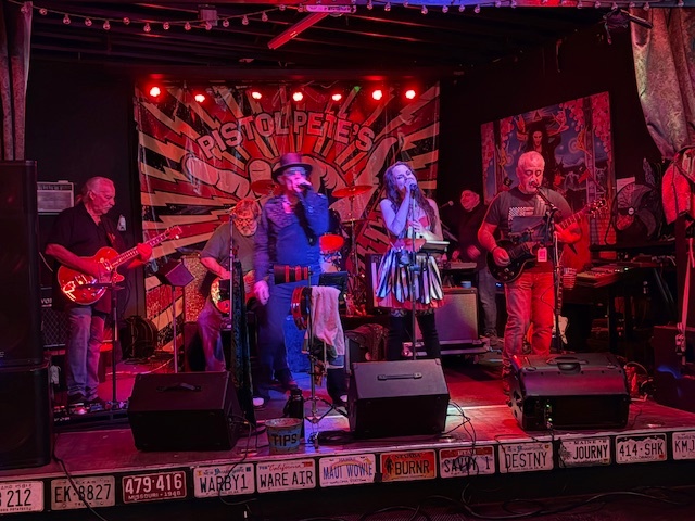 a group of people on stage at a music venue