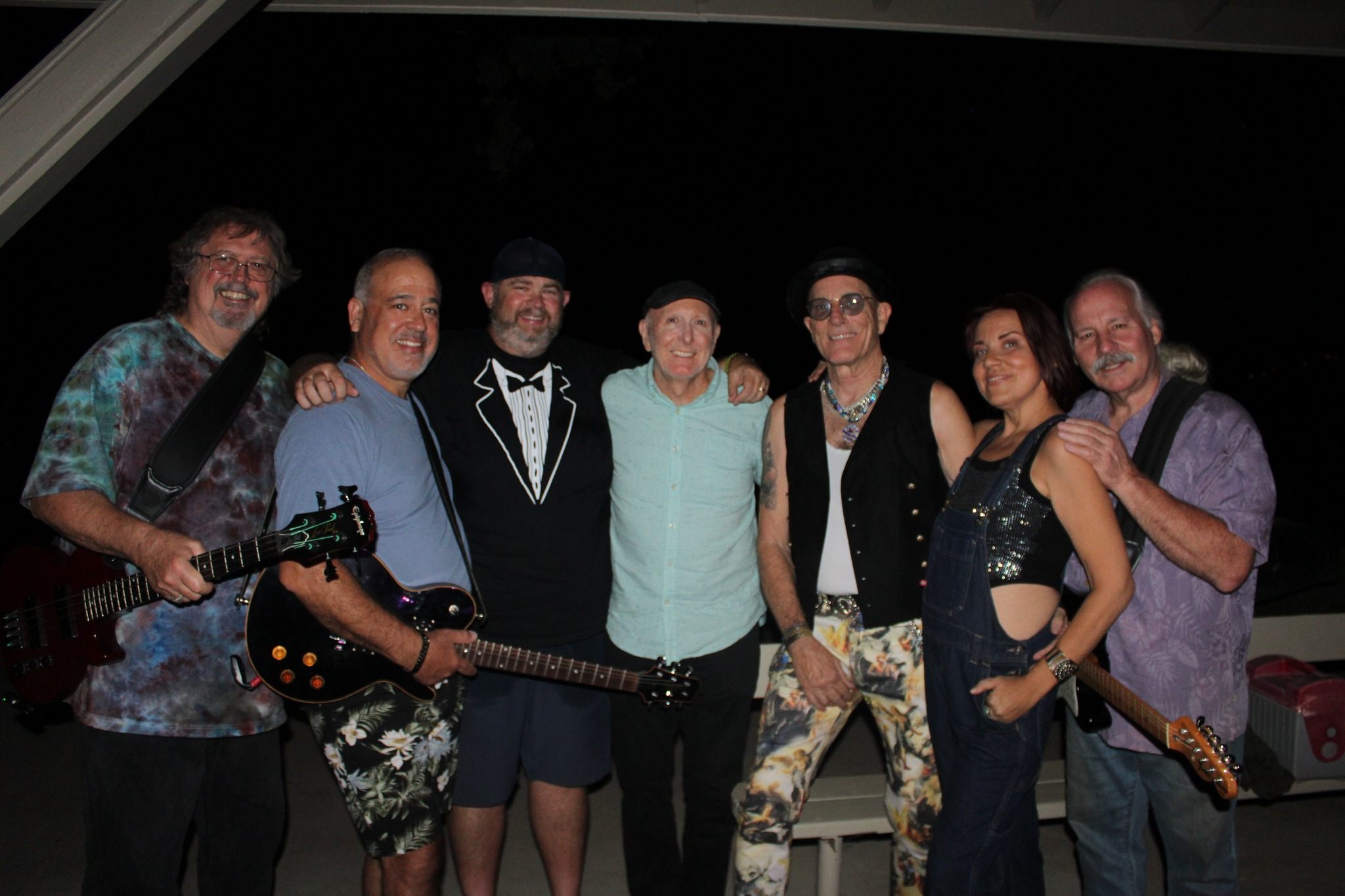a group of people posing for a picture with guitars