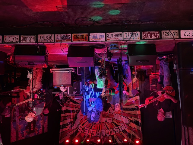 a room with a lot of lights and posters on the ceiling