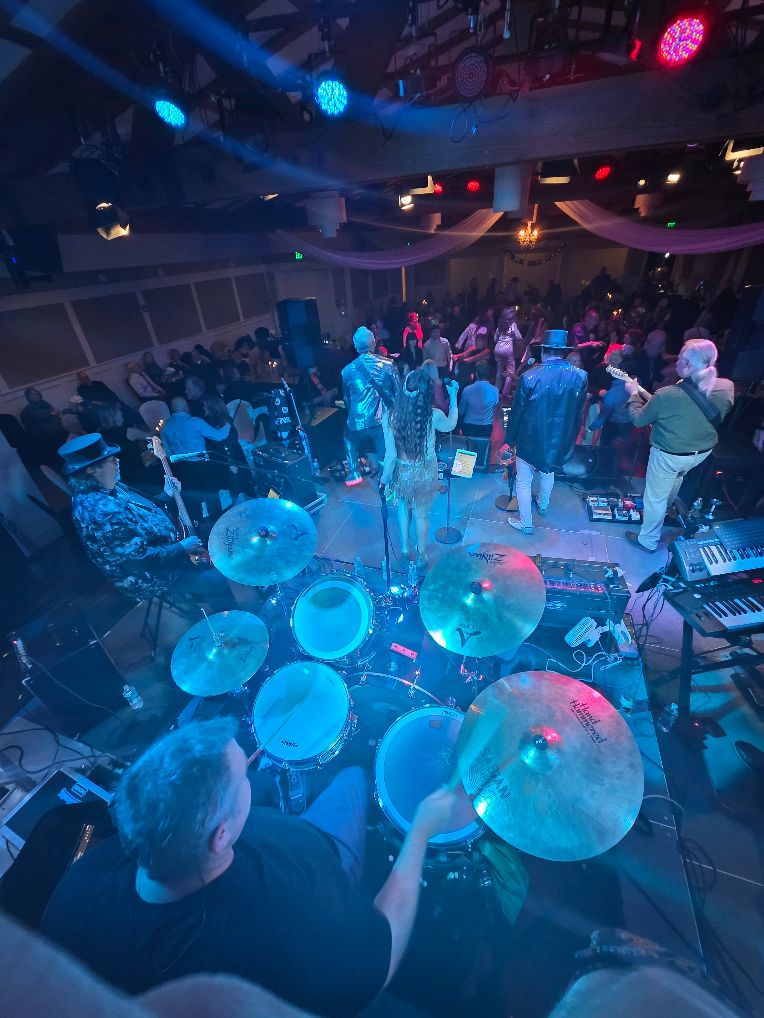 a group of people playing drums in a room