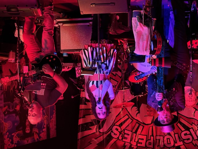 a group of people on stage in a dark room