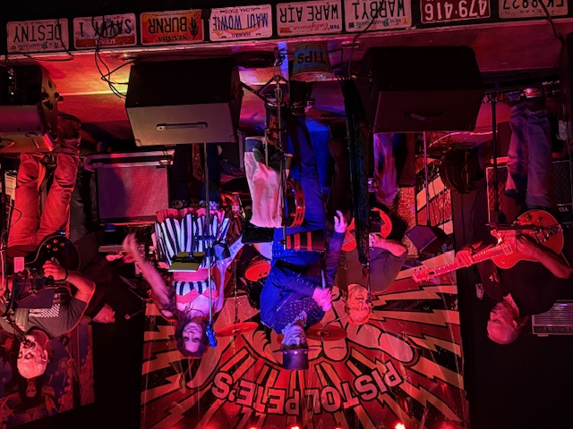 a group of people standing on stage in a dark room