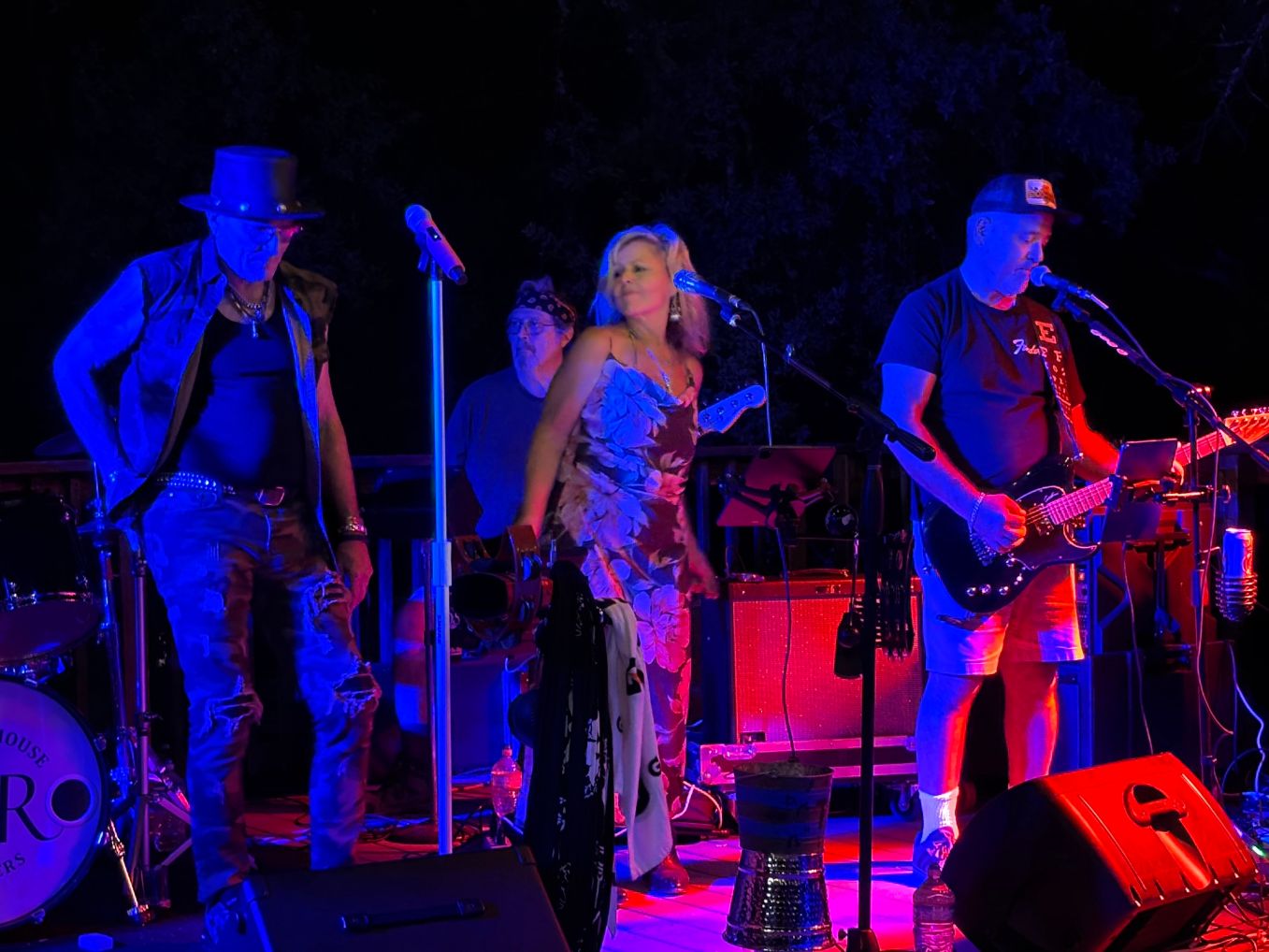 a group of people standing on stage at night