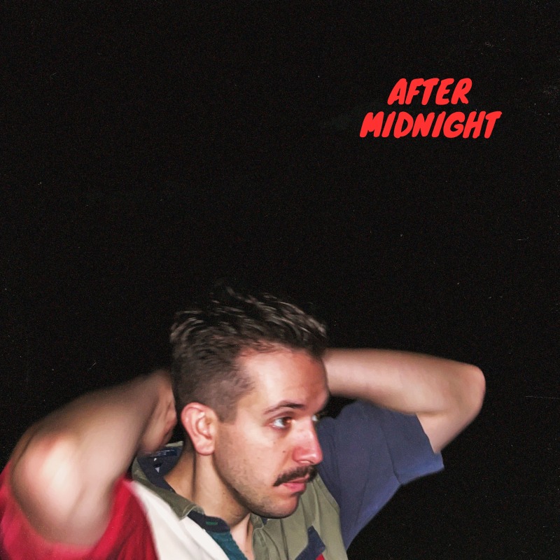 a man with a mustache is holding his hair up