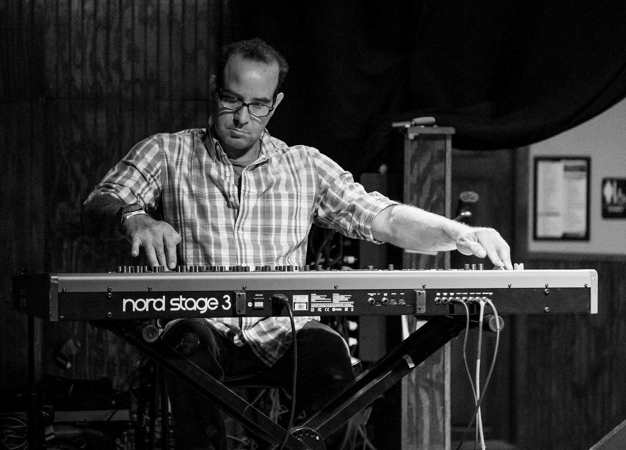 black and white photo of a man playing a keyboard