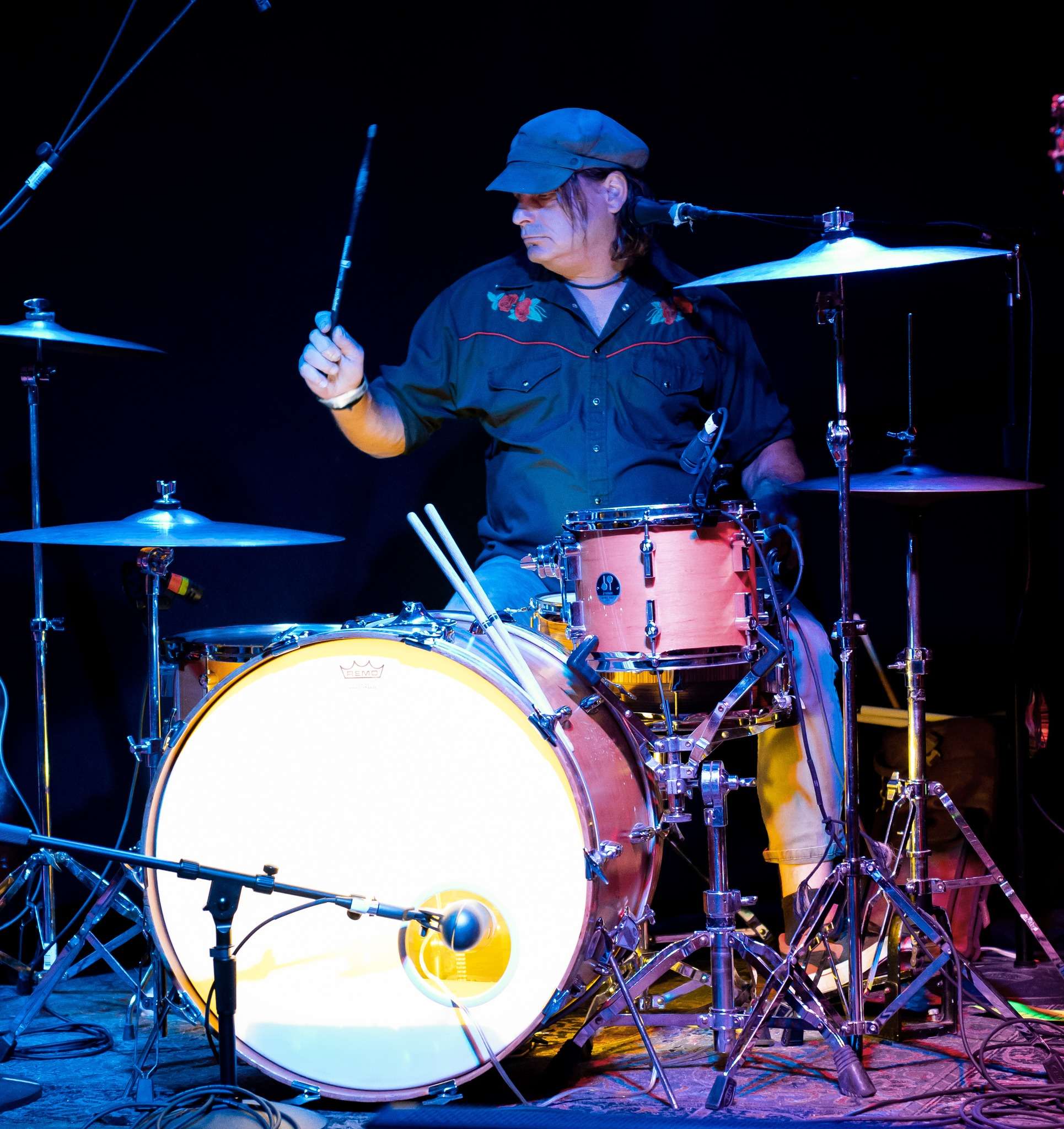 a man playing drums on a stage
