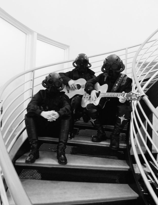 a black and white photo of a group of people sitting on stairs