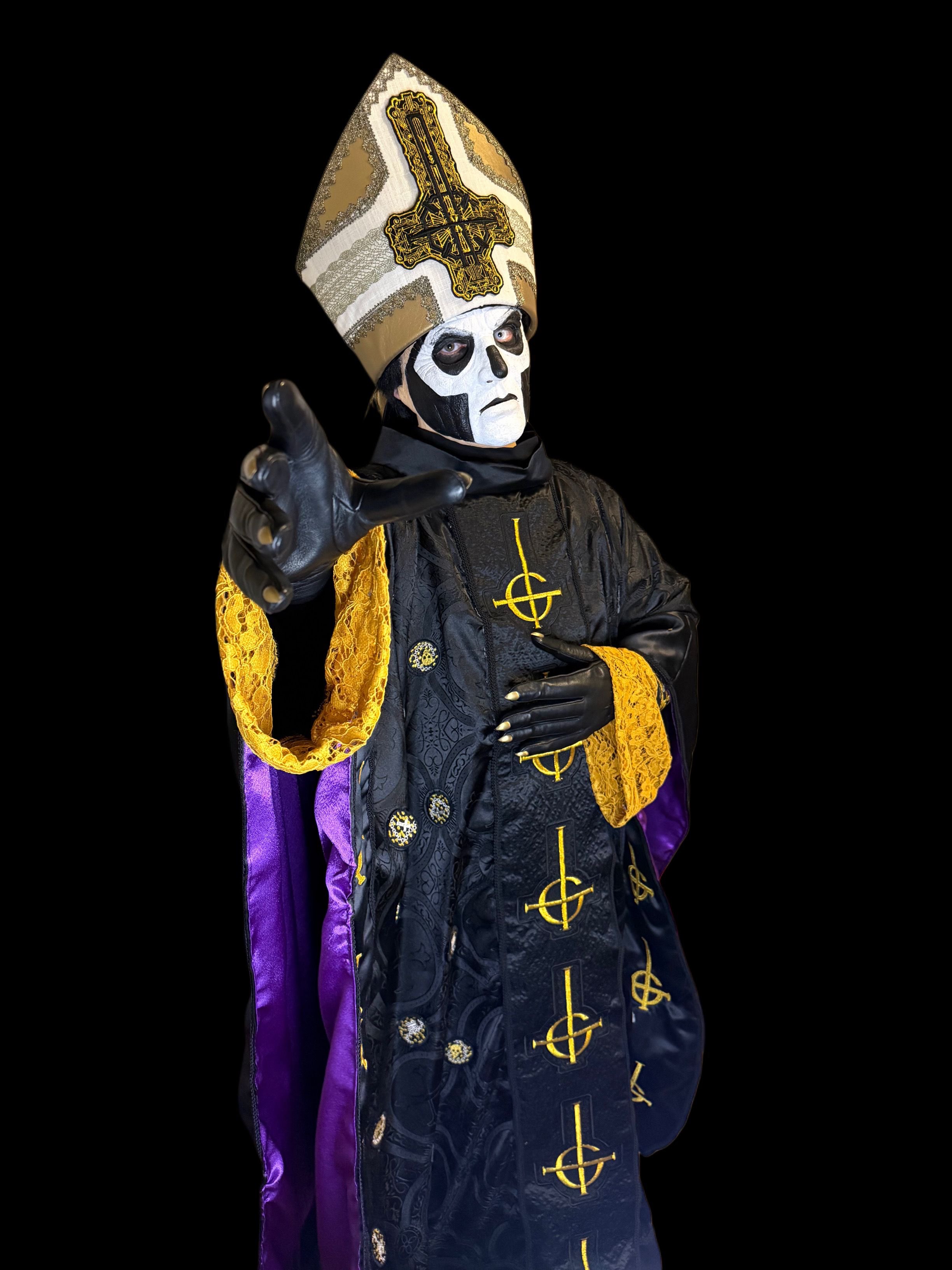 a priest in a black and gold costume