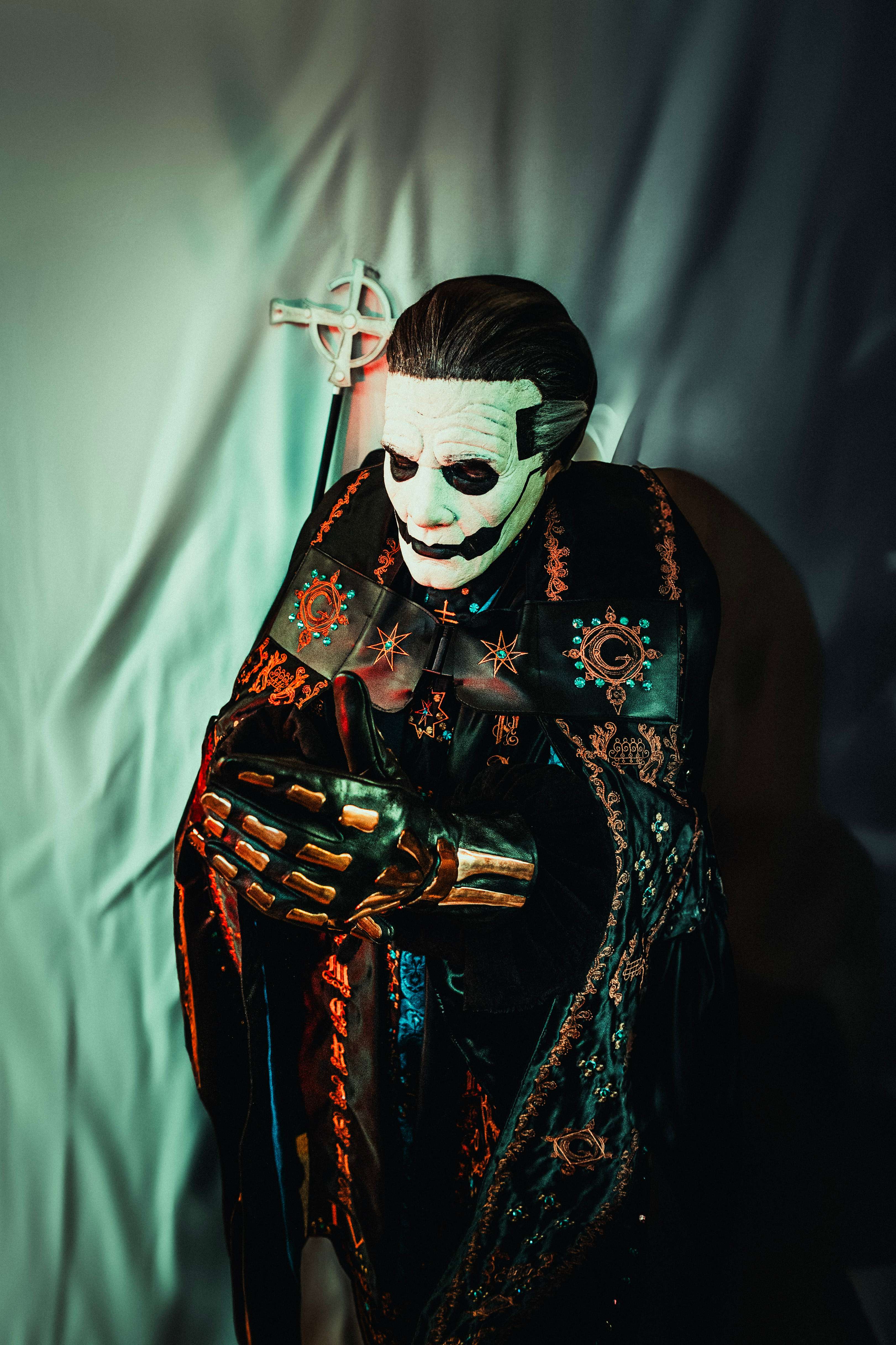a man dressed as a skeleton holding a sword