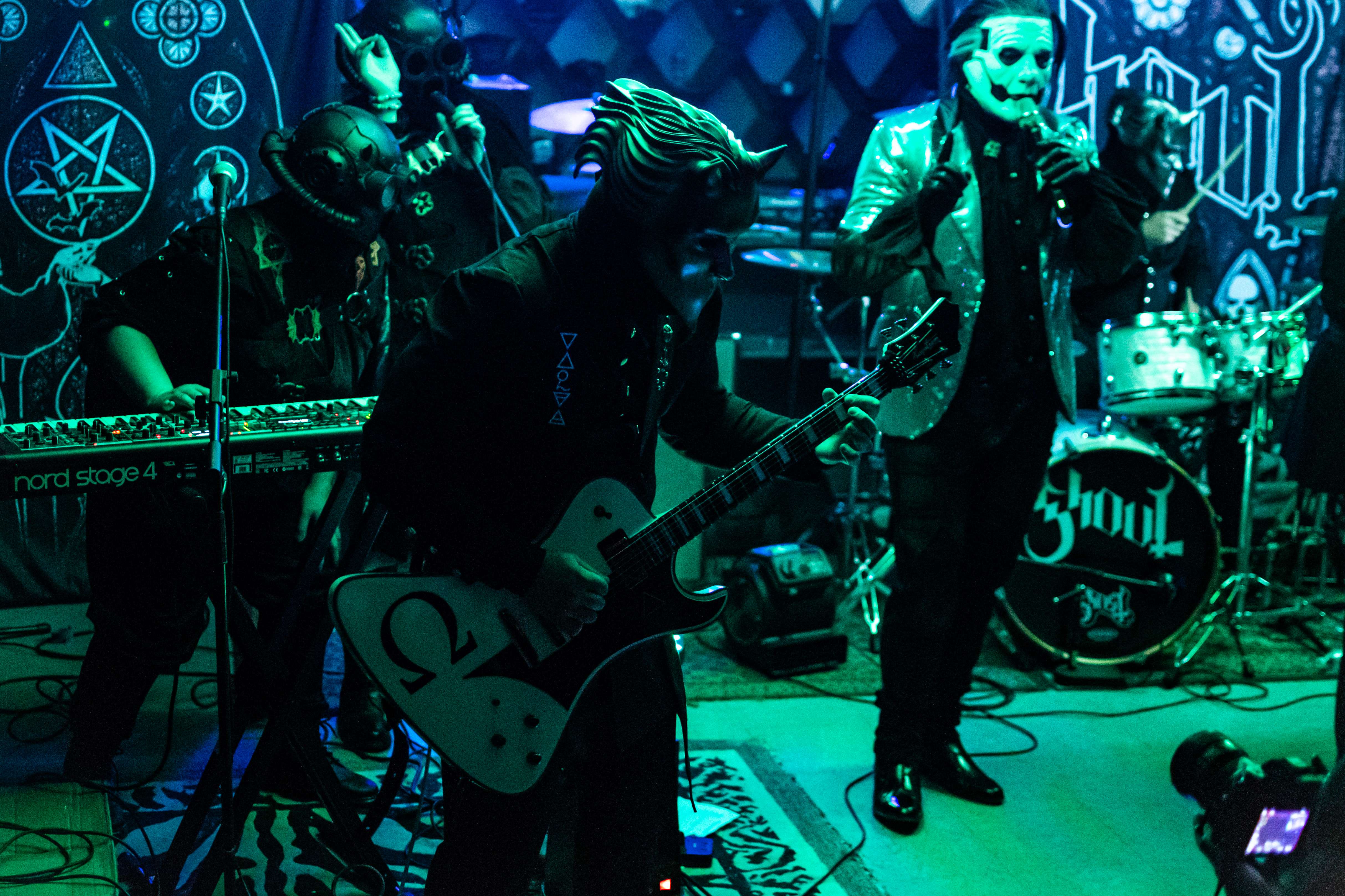 a group of people playing music in a dark room