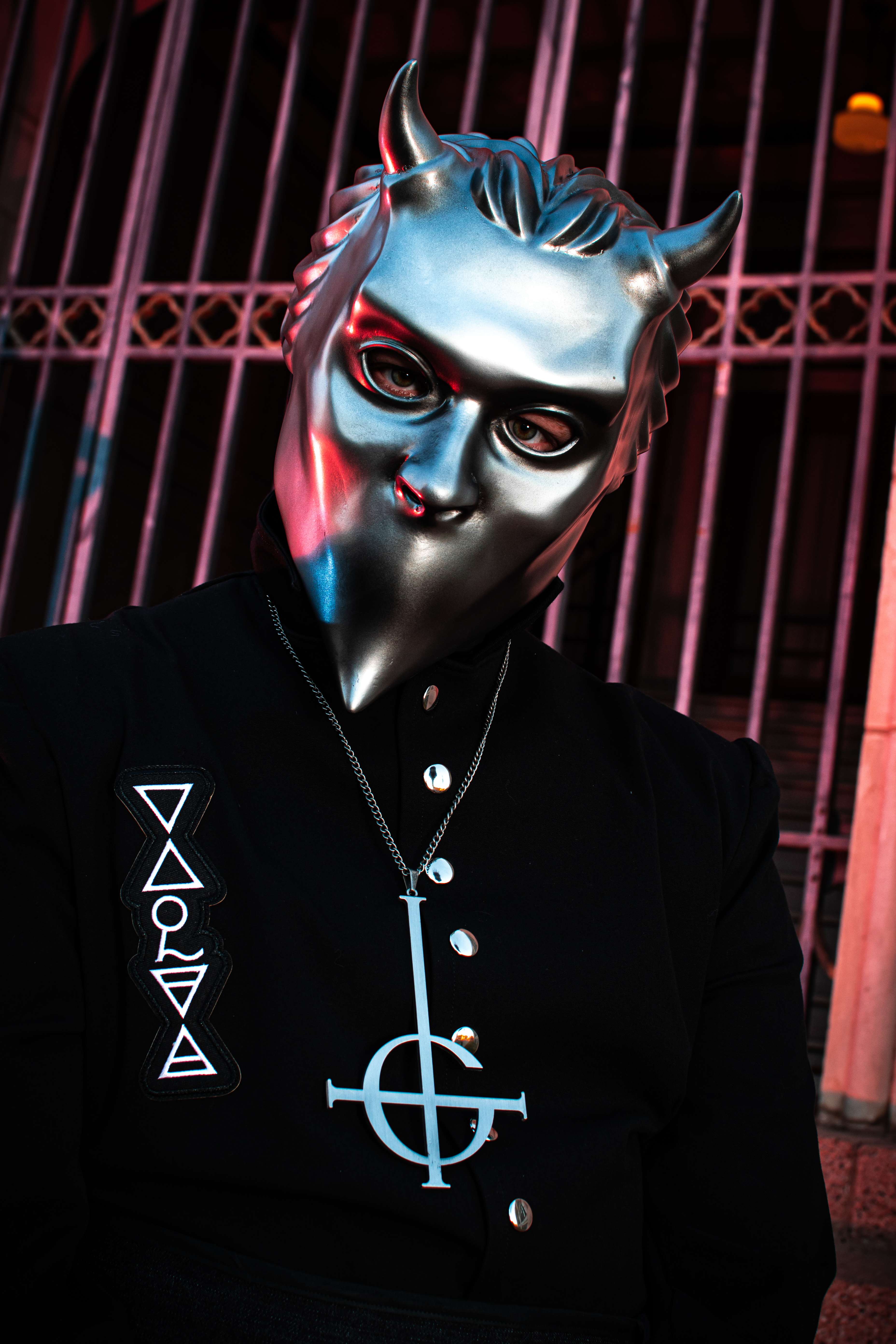 a person wearing a silver mask