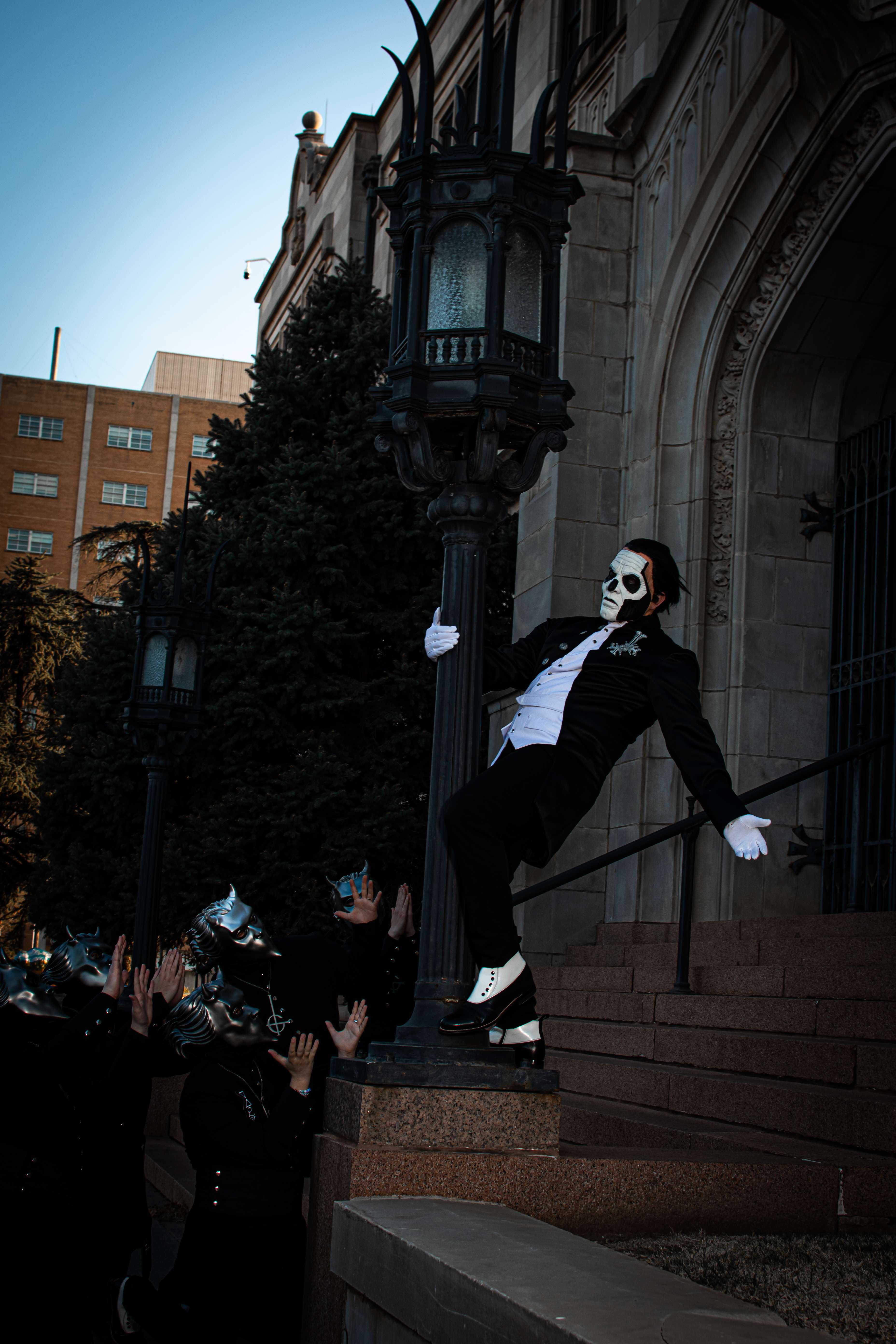 a man in a tuxedo doing a trick on a skateboard