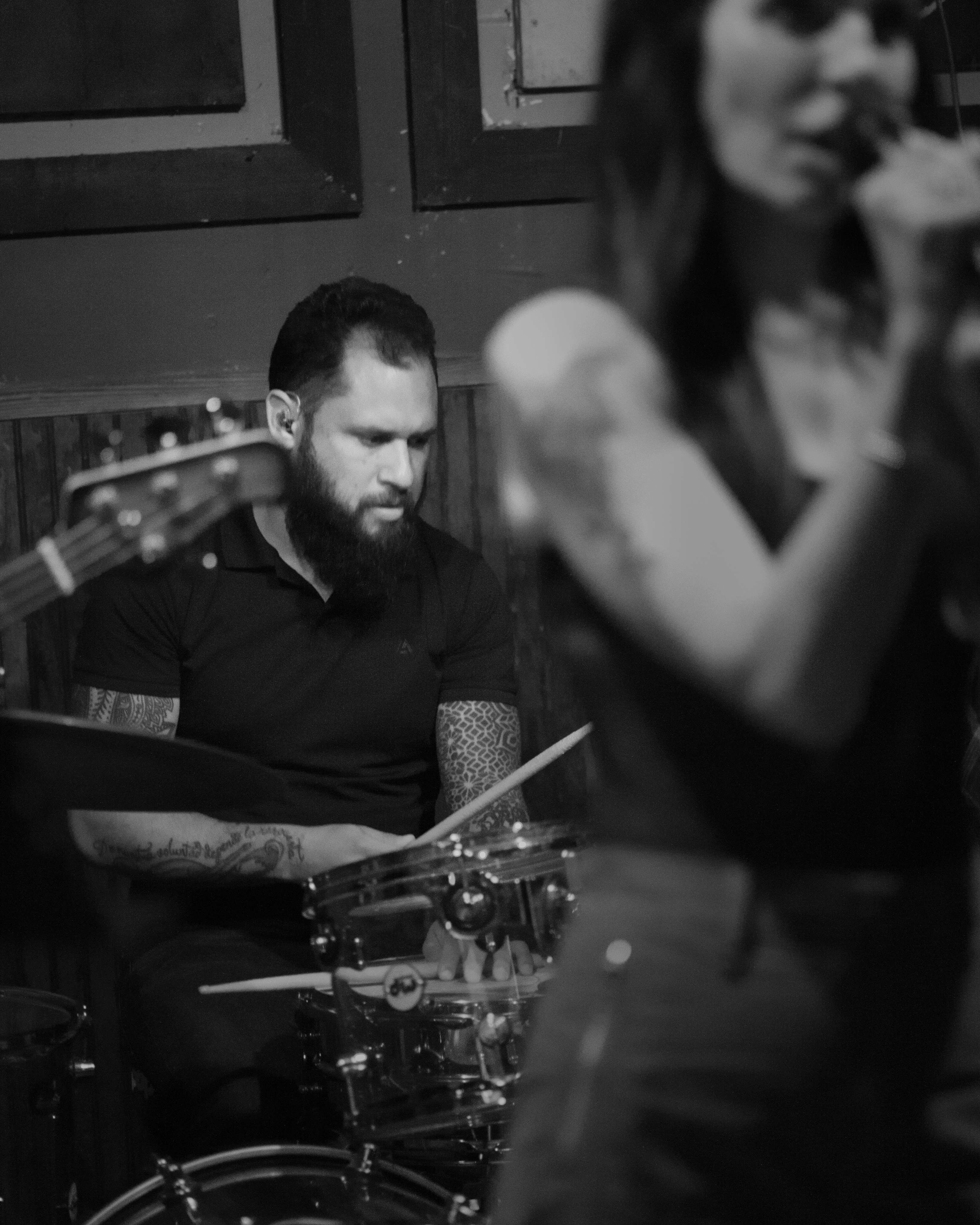 black and white photo of a group of people playing drums
