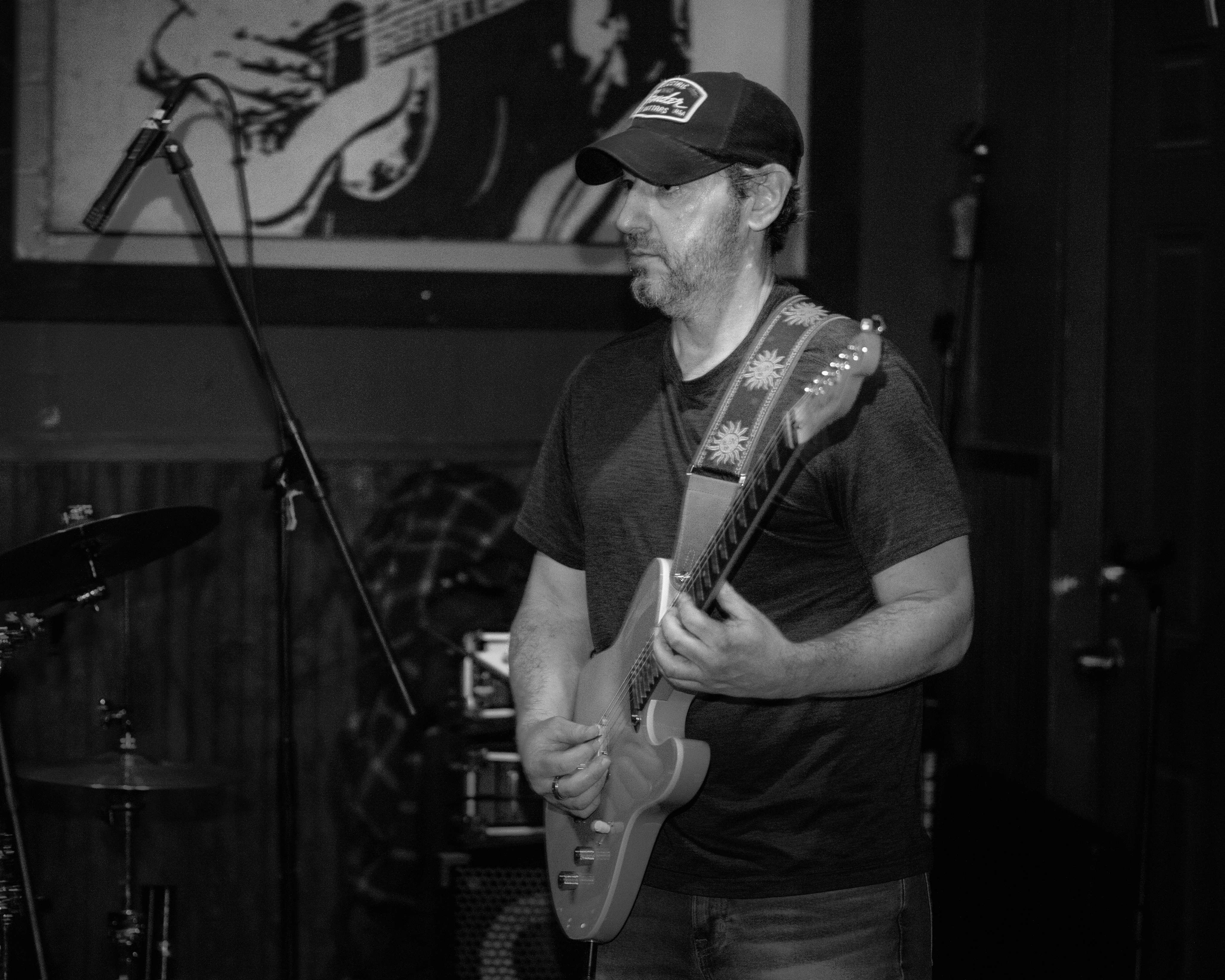 image may contain person, on stage, playing a musical instrument and night