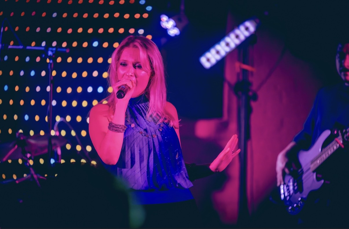 a woman singing into a microphone at a concert