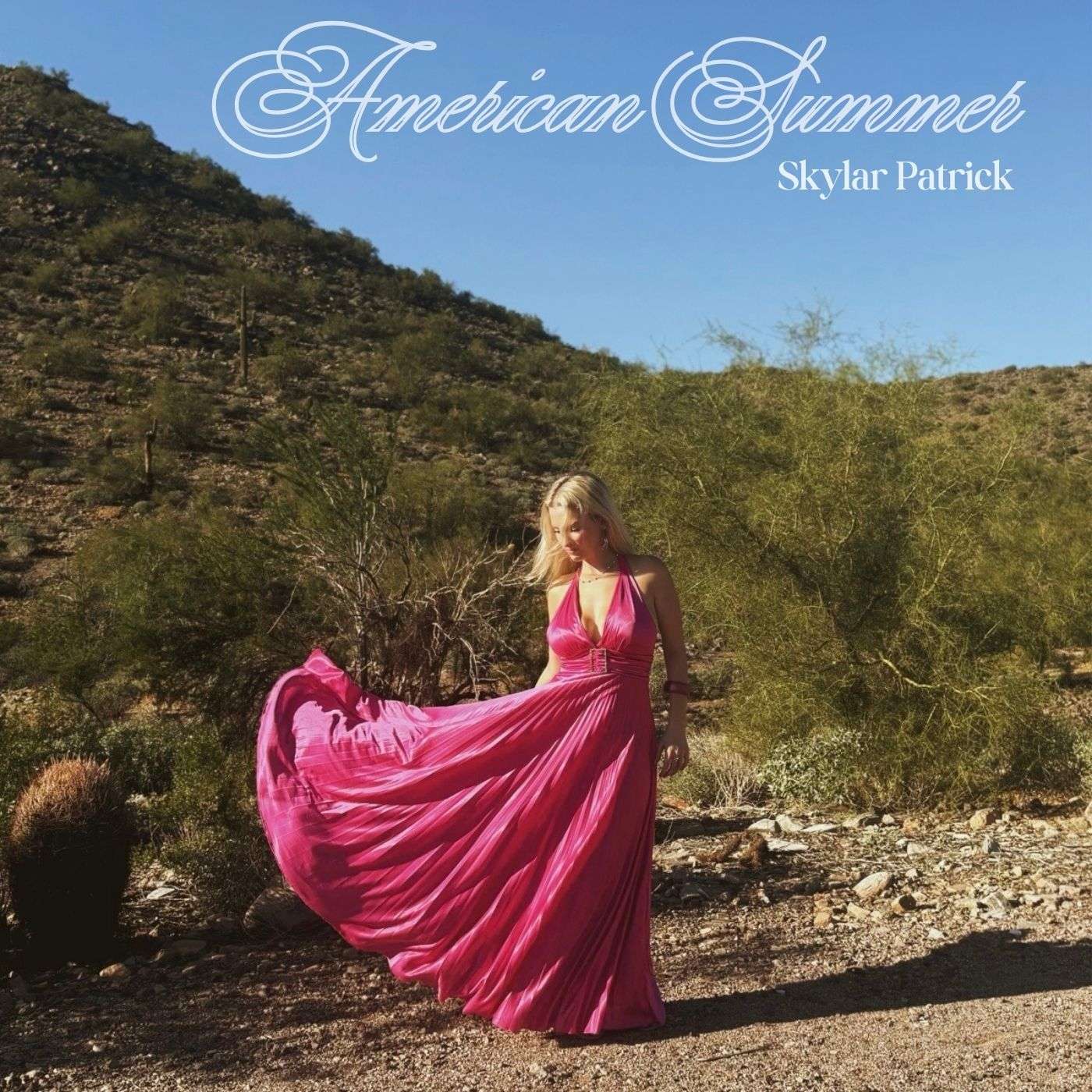 a woman in a pink dress standing in a desert