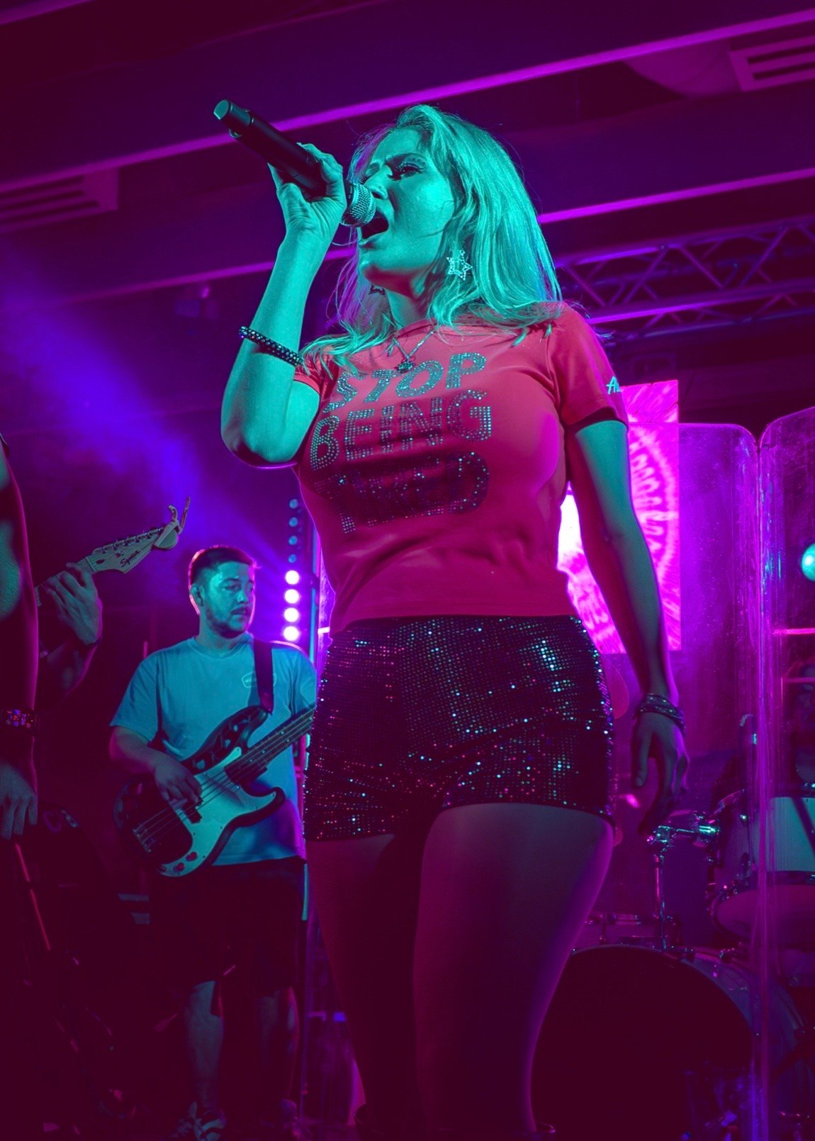 a woman singing into a microphone at a concert
