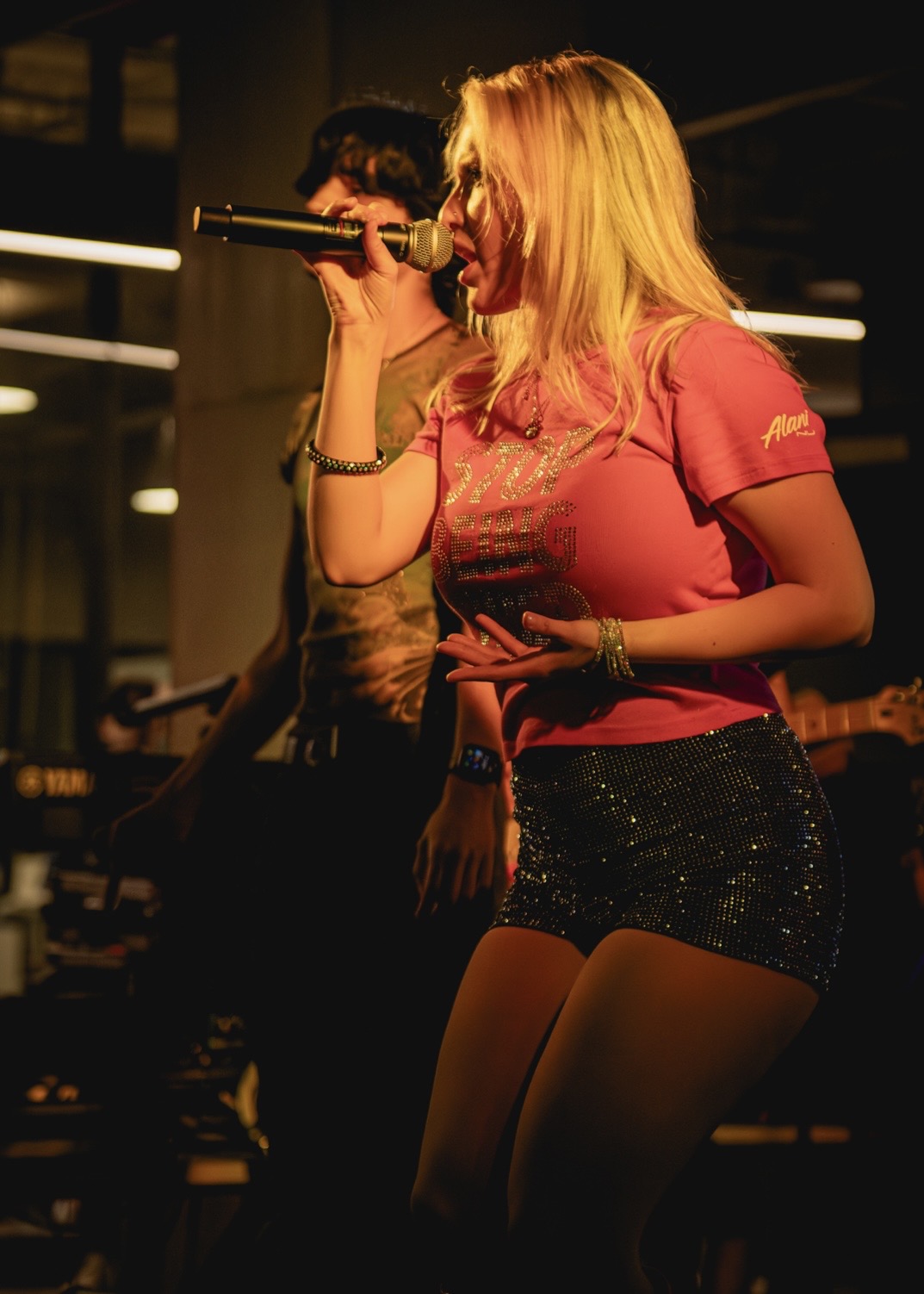 a woman singing into a microphone