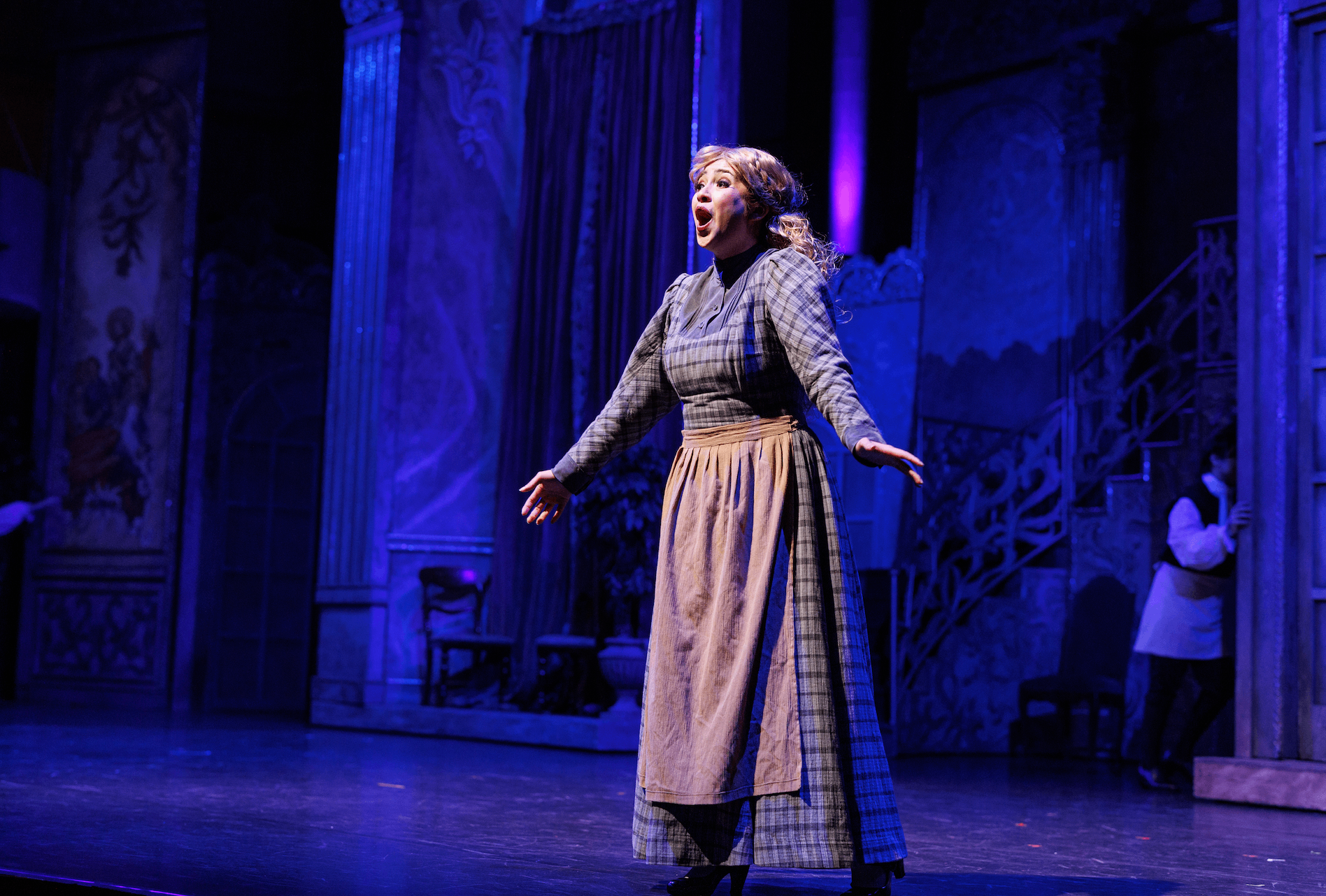 a woman in a dress on a stage