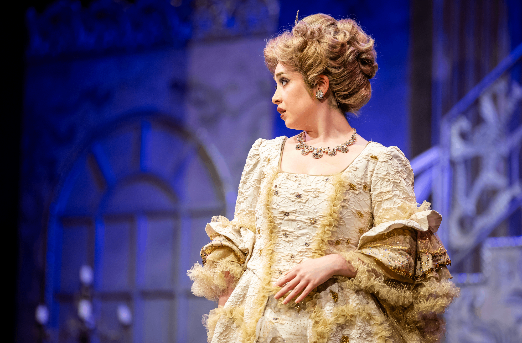 a woman in an ornate costume on stage