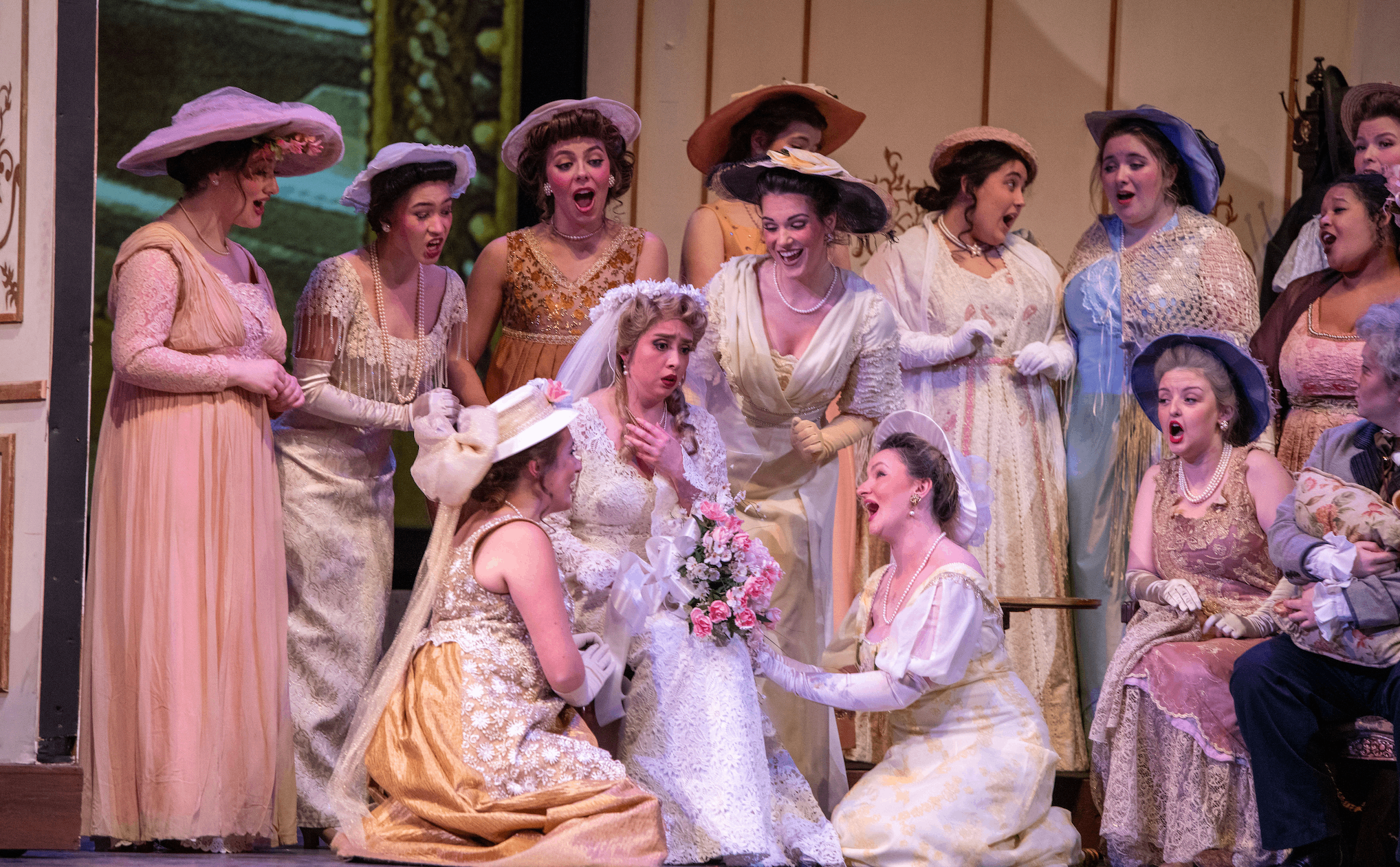 a group of women dressed in period costumes on stage